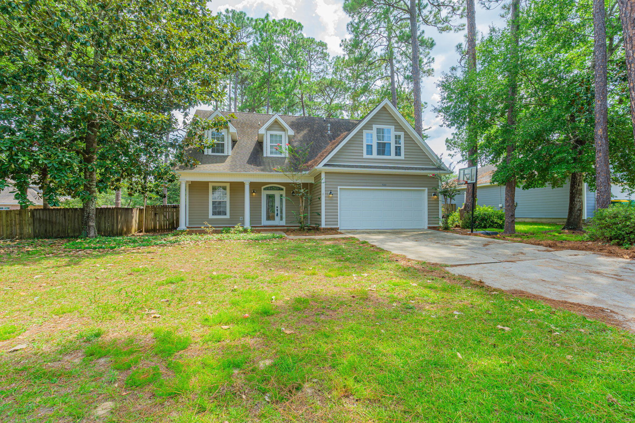 This stunning home features cedar ceilings, vaulted spaces, and real hardwood floors in the foyer. With 4 spacious bedrooms and 2.5 bathrooms, there's room for everyone and each bedroom includes at least one walk-in closet for ample storage. One upstairs bedroom even has a secret play area built under the eaves, perfect for imaginative kids or pets. Enjoy the comfort of built-ins and many custom touches that make this home truly one-of-a-kind. The fully fenced backyard is an entertainer's dream with a large, screened patio, ideal for year-round outdoor living. Located just 2 blocks from water access where you can launch your kayak or paddle board. Added bonus it is central to shopping, restaurants, and schools. This home blends convenience with charm and location. Contact us today for your showing!!