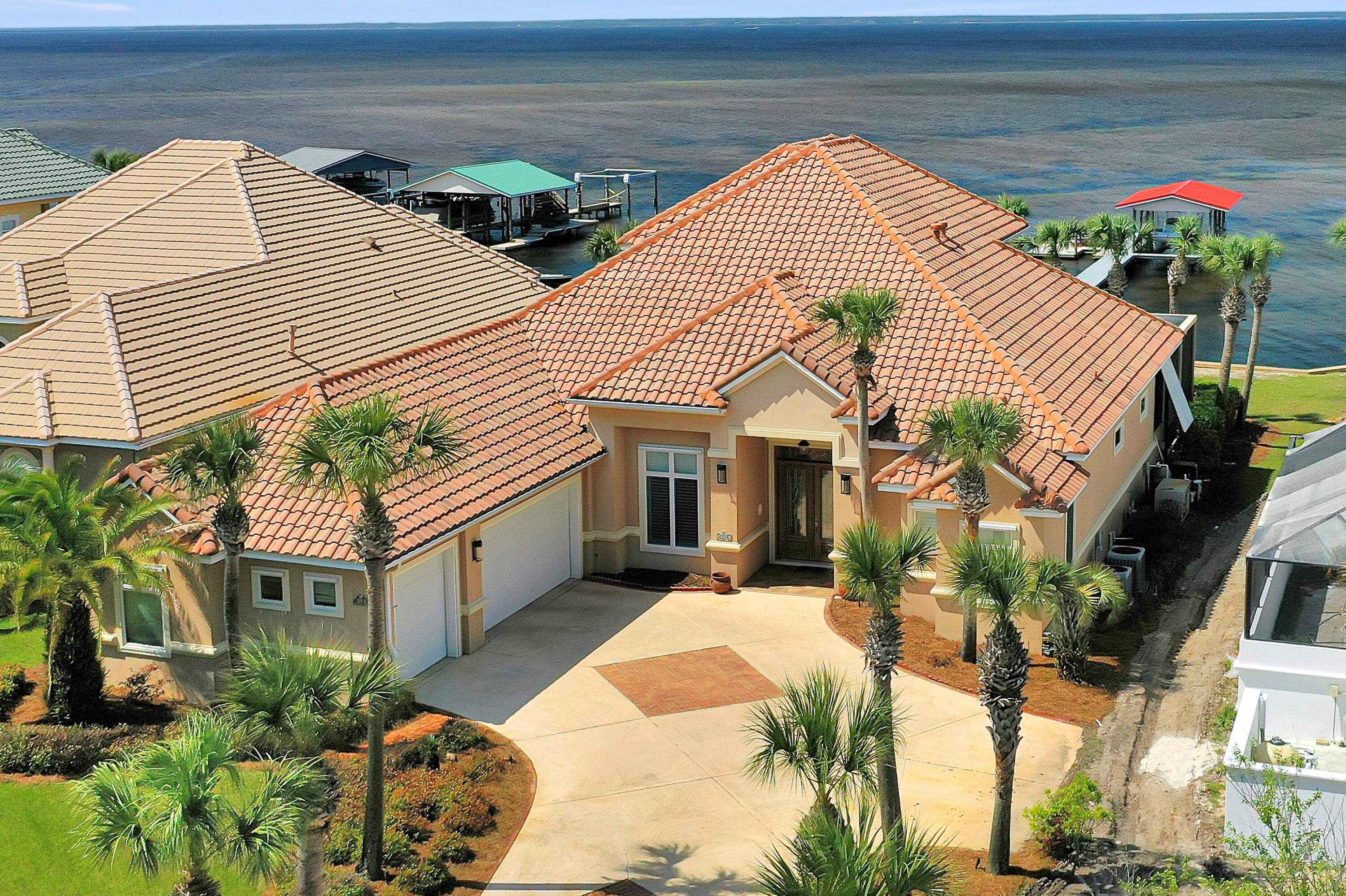 *BEST VALUE FOR A BAYFRONT HOME IN MIRAMAR BEACH* WHOLE HOUSE GENERATOR, HURRICANE SHUTTERS, RID O  RUST SYSTEM, NEW DOCK FALL 2020. THIS 2 STORY FLOOR PLAN  FEATURES MAIN LIVING ON 1ST FLOOR INCLUSIVE OF FORMAL + CASUAL SPACES, MASTER SUITE, GUEST BEDROOM AND BATH LAUNDRY, FULL POOL BATH AND OFFICE OVERLOOKING BAY. 2ND FLOOR IS CURRENTLY SITUATED AS 2 GUEST BEDROOMS AND BATH + EFFICIENCY KITCHEN. INTERIOR FOCUSES ON GORGEOUS BAY VIEWS THROUGH OPEN AND FLOWING FLOORPLAN. IMPECCABLE APPOINTMENTS INCLUDE PORCELAIN TILE, CROWN MOLDING, 10-14 FOOT CEILINGS,TRANSOM WINDOWS, CALIFORNIA CLOSETS IN MASTER SUITE, ANDERSON WINDOWS AND SLIDING GLASS DOORS, SECURITY/SURROUND SOUND, BUILT-IN PEST CONTROL (PEST GARD) GENERAC GENERATOR (WITH WARRANTY), GRANITE COUNTER-TOPS, CUSTOM CABINETS, GE MONOGRAM APPLIANCES, BRUSHED NICKEL BATH FIXTURES, GAS FIREPLACE, SUMMER KITCHEN, SWIMMING POOL AND TREXX/FLOW THRU LINED DOCK (NEW IN 2020) WITH COVERED BOATHOUSE AND 8,000 POUND LIFT. A/C'S AND WATER HEATERS NEW IN 2017 AND 2018. AMAZINGLY CONVENIENT LOCATION WITHIN CLOSE PROXIMITY TO SHOPPING, DINING AND BEACH.''SUNBURST ON THE BAY'' IS AN INTIMATE WATER FRONT COMMUNITY WITH JUST 6 PREMIER PROPERTIES ALL BUILT BY AWARD WINNING DKM CUSTOM HOMES.