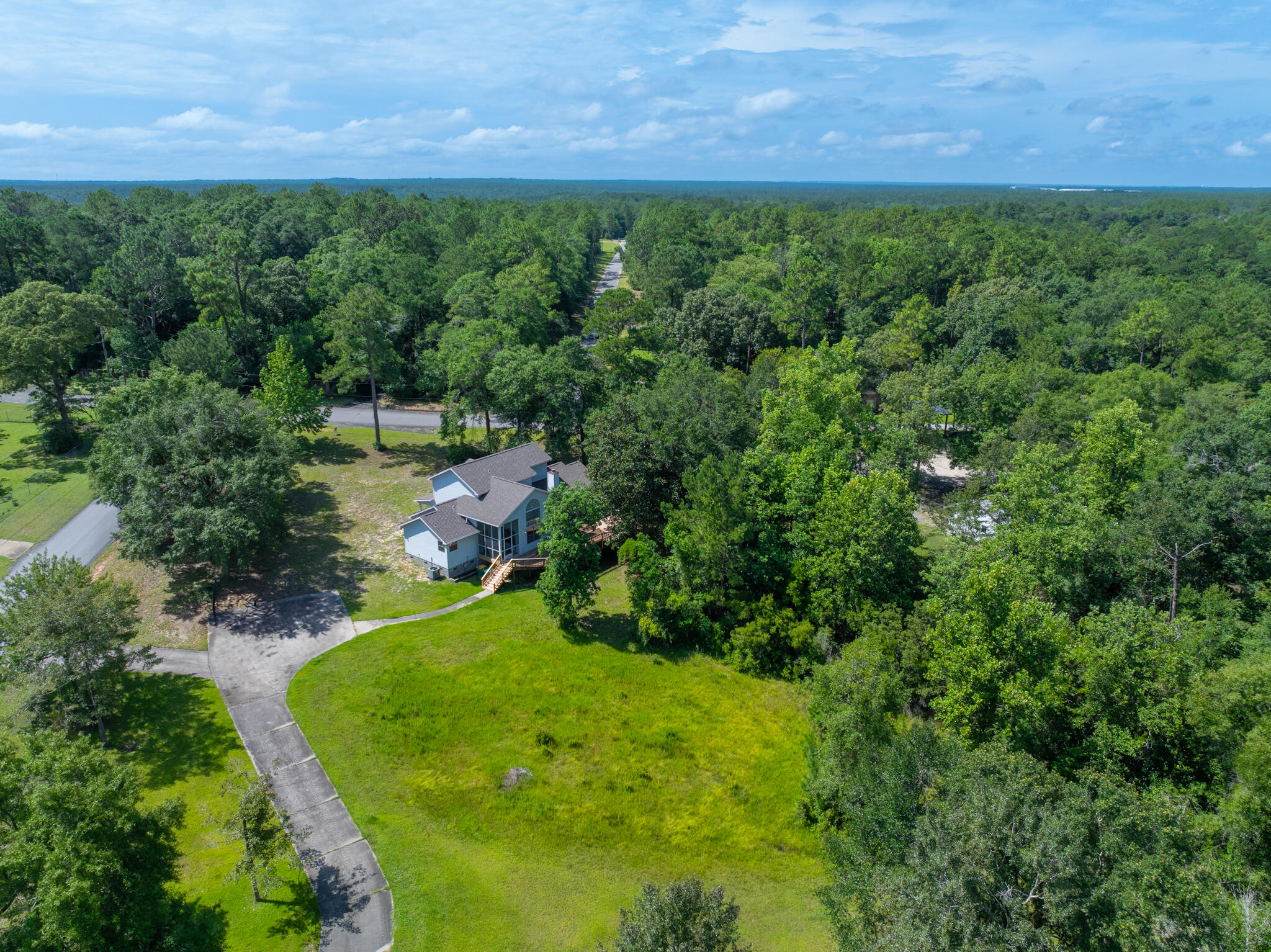 **New Lower Interest Rates Make This a Must-See!**
This unique, one-owner custom home on 4.66 partially wooded acres is perfect for those who love working with their hands, living close to nature, or simply want space to grow. Whether you're into car restoration, woodworking, homesteading, or all of the above—this property is ready for your next chapter.

The freshly painted interior and new carpet in the living room and primary suite add a fresh, move-in-ready touch. A new roof in 2024 provides peace of mind for years to come.

The main floor features a spacious primary suite with attached flex space—ideal as a nursery, reading nook, or home office. The en-suite bath includes dual vanities, a garden tub, walk-in shower with dual heads... and a large walk-in closet. The living room boasts soaring ceilings, a gas fireplace, and a nearly floor-to-ceiling window that fills the space with natural light. The open layout flows into the dining area, family room, and a kitchen complete with a walk-in pantry and backyard views.

Upstairs are two large bedrooms, a full bath, and a loft-style landing that overlooks the living room below. Off the utility/laundry room is a screened patio that opens to a huge two-level deckperfect for gatherings, relaxing mornings, or watching deer wander by.

But the real gem? A 3-bay detached workshop with full power, climate control, bathroom, water, and plumbing for a showerideal for auto work, woodworking, or serious hobbies. A tall carport and two more storage buildings add even more flexibility for RVs, equipment, or tools.

Outside, there's room to homestead with cleared land for gardens, chickens, greenhouses, or even horsesplus mature trees for privacy and wildlife.

Quiet rural living just minutes from townthis is more than a home. It's a lifestyle waiting for your vision.