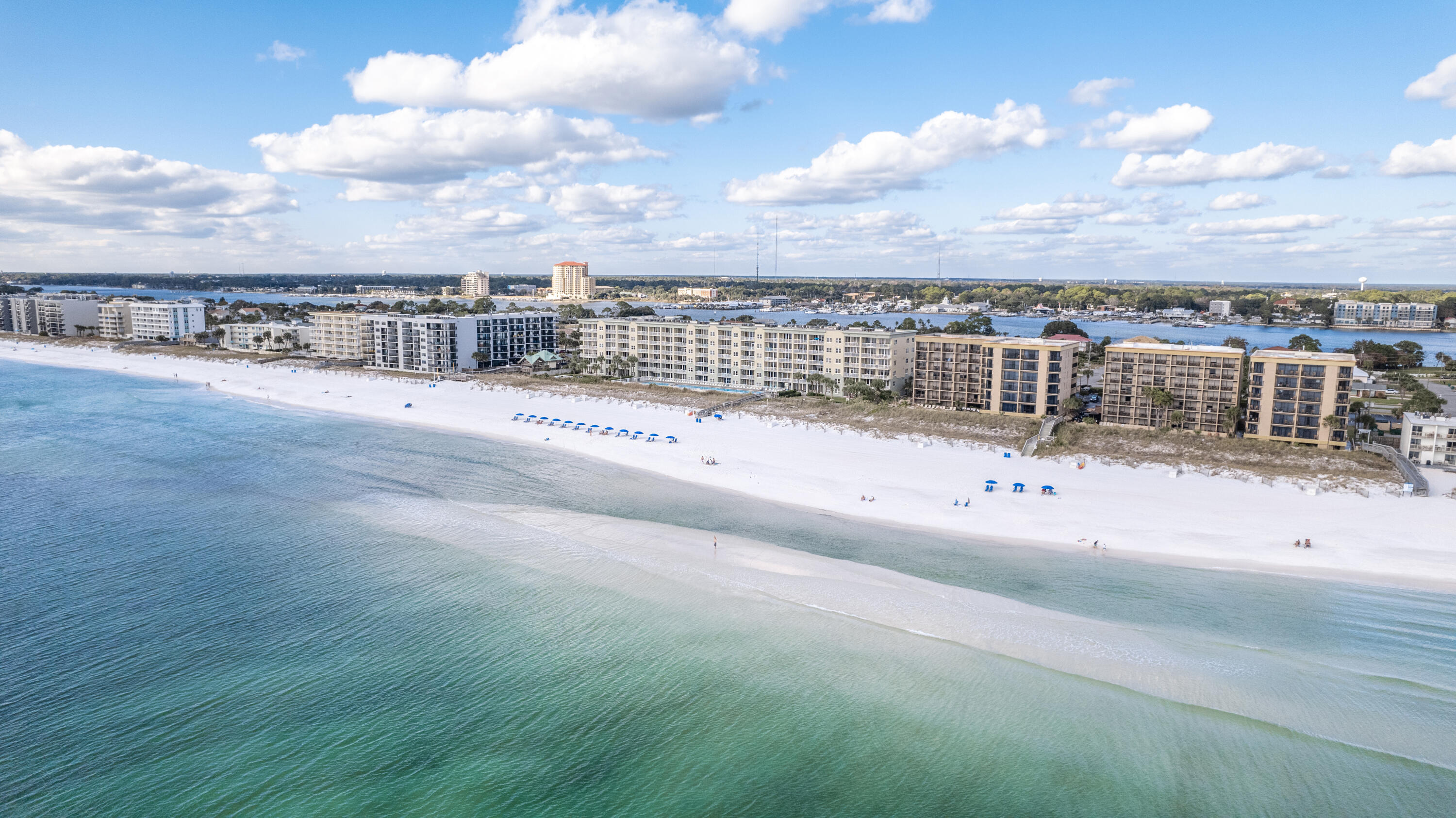 This fourth-floor unit at Waters Edge offers stunning panoramic Gulf views! The combined main living area, dining room, and kitchen all feature breathtaking views through large glass sliders. Granite countertops and updated stainless steel appliances give the kitchen a clean look. The spacious balcony allows you to take in the views and sea breeze from sunrise to sunset. The master suite is located in the north end of the unit and there are hallway bunks. With two full bathrooms, island-influenced style and décor, easy-to-maintain tile flooring throughout, and a desirable location this unit makes a fantastic rental property! Waters Edge is a desirable Gulf-front community with fabulous amenities including two Gulf-front pools, a beachfront gazebo, grilling and picnic area, parking garage, fitness center, and a boardwalk to the beautiful beachfront with showers to rinse off after a full day at the beach. Paradise!