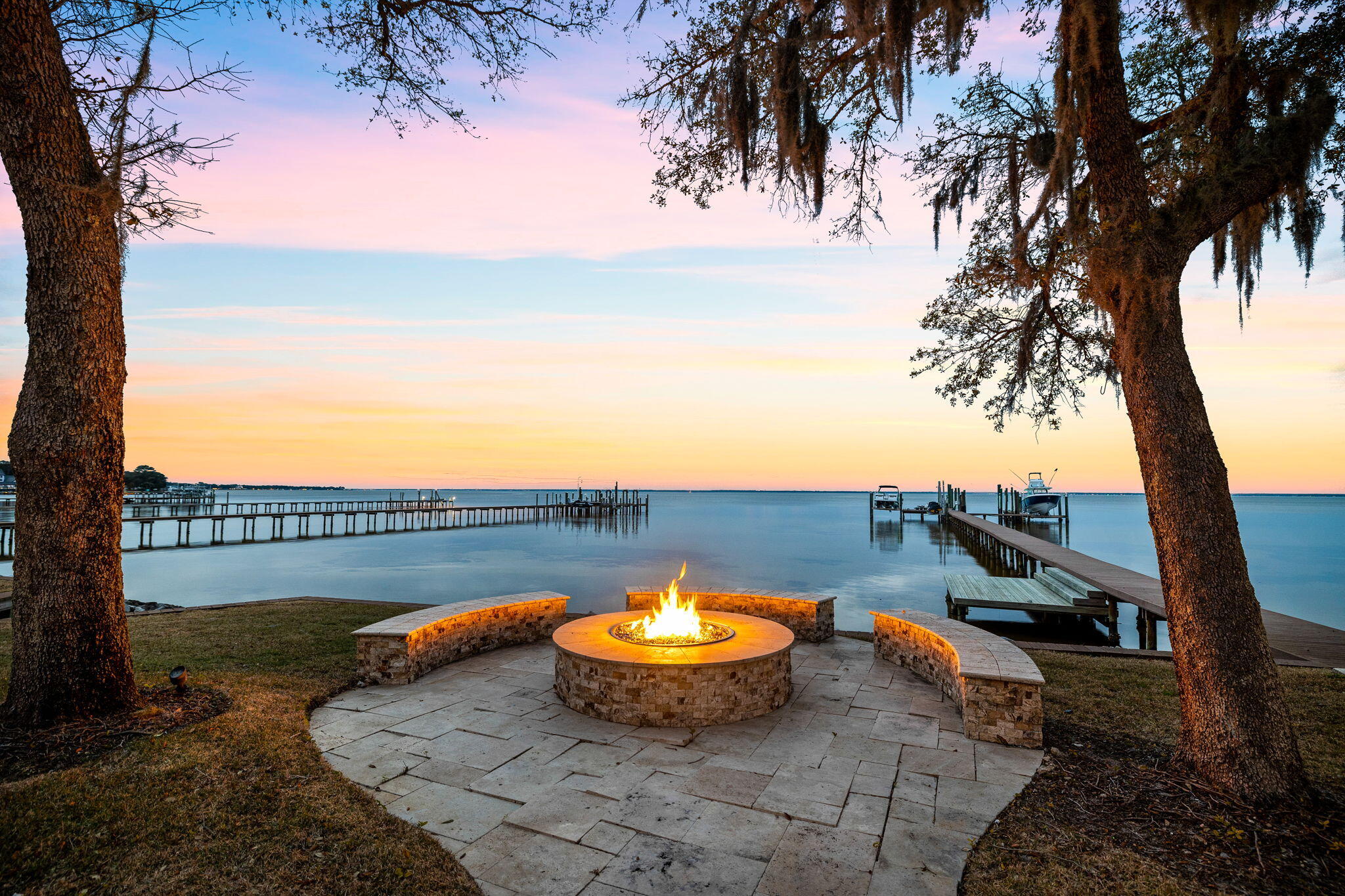 Nestled within the exclusive gated community of Kelly Plantation, this meticulously crafted deep water estate offers over 220' of prime frontage on the Choctawhatchee Bay, set on an acre of land for unparalleled privacy. Boasting exceptional proximity to world-class amenities, dining, and entertainment in Destin, Florida, this masterfully positioned property presents an extraordinary opportunity for luxurious coastal living.

The expansive private dock, previously accommodating a 75' yacht, features low maintenance trex decking, 3 jet ski lifts, a paddle board launch, and two deep water boat slips each with lifts. Architectural grandeur harmonizes with lush tropical landscaping and expansive motor court to create a captivating entrance to this elegant compound home. The main residence showcases predominantly single-level living, maximizing the breathtaking bay views and northwest orientation. The first level primary suite offers a spacious living area, direct access to the rear screened lanai overlooking the water, and a spa-like ensuite bathroom and enormous closets. Smart home technology and meticulous maintenance ensure seamless modern living.

The chef's kitchen, adjoined to the private screened lanai, formal living room and formal dining, features custom cabinetry, a Wolf gas range, Sub Zero refrigeration, and solid stone countertops. The outdoor living area, a true oasis of privacy, encompasses a screened sun deck, pool & spa, outdoor grilling area, and a covered patio with a gas fireplace, pool bath, and a pool house guest suite for your special guests.  Additionally, there is an expansive 3 car garage and exercise room with a 2nd level carriage house, complete with its own kitchen, living room, powder bath and full guest suite, adding to the property's allure and versatility.

Additional highlights include four guest suites on the second level of the main house, a private office space and an in-home movie theatre ideal for a large family or exceptional entertaining.  This rare offering within Kelly Plantation presents an unparalleled opportunity to secure a deep water property with open Bay views, complemented by its convenient proximity to Whole Foods, esteemed schools, airports, and the renowned white sand beaches of the Emerald Coast.