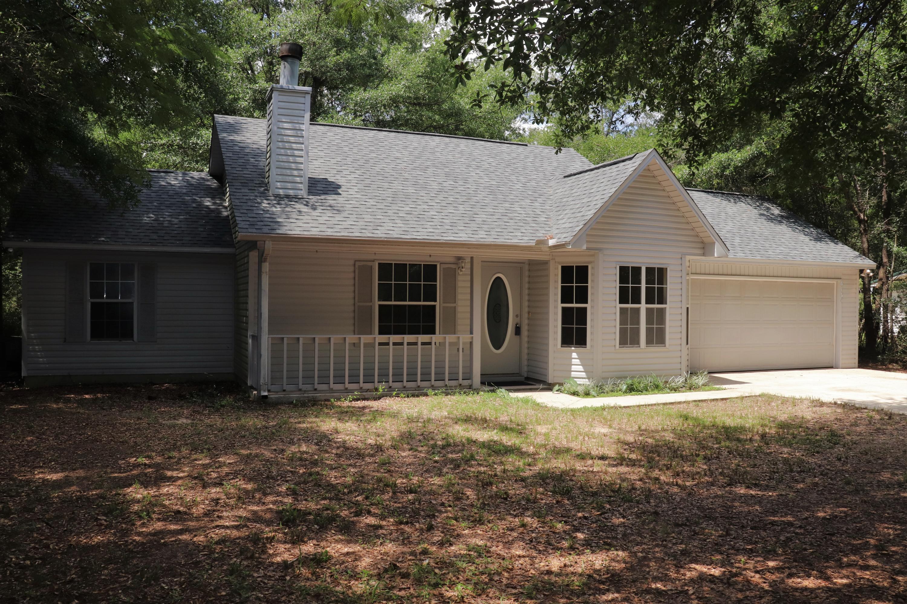 BRAND NEW roof, wood laminate flooring throughout home, paint, Kitchen cabinets and counter tops, stove/oven, dishwasher, water heater, and Bathroom vanities! Wow! Enjoy county taxes while nestled on 1.46 acres! As you enter the home into Living Room, you're greeted with high ceilings that features large stone fireplace. Eat-In Kitchen offers lots of natural light with bay windows overlooking private front yard. Brand new counter tops, white cabinets (with Lazy Susan) and Whirlpool stove/oven and dishwasher. 2 car Garage is accessed off of Kitchen, and is true to size. Master Bedroom continues with high ceilings with large walk-in closet and beautiful new vanity. Just off of Master Bedroom door is access to covered back porch. Lots of room to enjoy peace and quiet! This home is a must see!