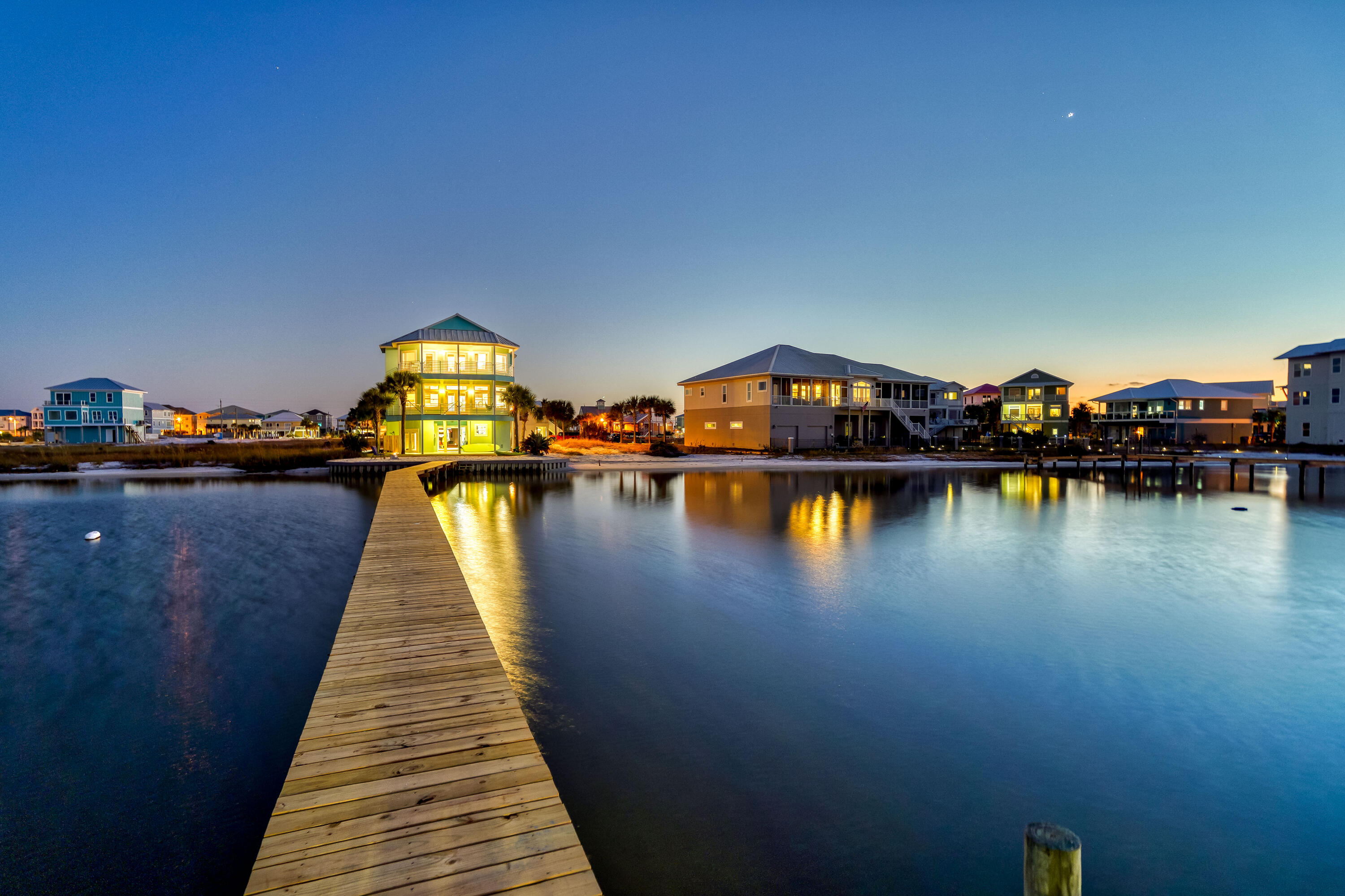 An enchanting home set directly on the Santa Rosa Sound, with panoramic views, over a mile of untouched Conservation Beach to the East and views of the Gulf! Breathtaking views encompass every level of this home, each with their own unique perspective. Enjoy your own private beach right in your backyard on the serene waters of the Santa Rosa Sound. This home features a private, recently renovated, boat dock and boat lift. Stepping in, you'll first notice the modern styling, tile flooring throughout the home and 10 foot ceilings. On the top level, the Southernly facing guest bedroom features a private balcony with Gulf views and a full bathroom. On the North side, the enormous Master Bedroom creates the illusion that you're perched right above the Sound. Pure bliss is awakening to the sun,