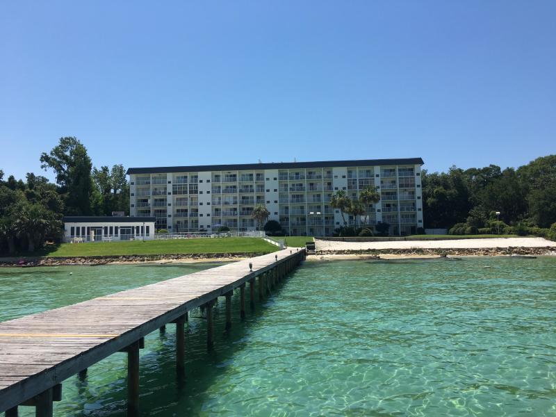 Waterfront and affordable! Enjoy great views of Choctawhatchee Bay and Crab Island from the living room and balcony. Small condo community features direct water access via private dock to Destin's famous Crab Island on Choctawhatchee Bay at the foot of East Pass and Destin Harbor. 2nd story condo with tongue-and-groove, real oak hardwood flooring in living room with a comfortable layout that flows well.  Private balcony overlooking, community Bay-front pool, with club house and tennis courts just minutes from beaches, restaurants, shopping and entertainment. Dock, benches, fish cleaning station and private sandy beach. On-site storage for kayaks and paddle boards. Easy living with on site maintenance staff. Would make a perfect low maintenance home.