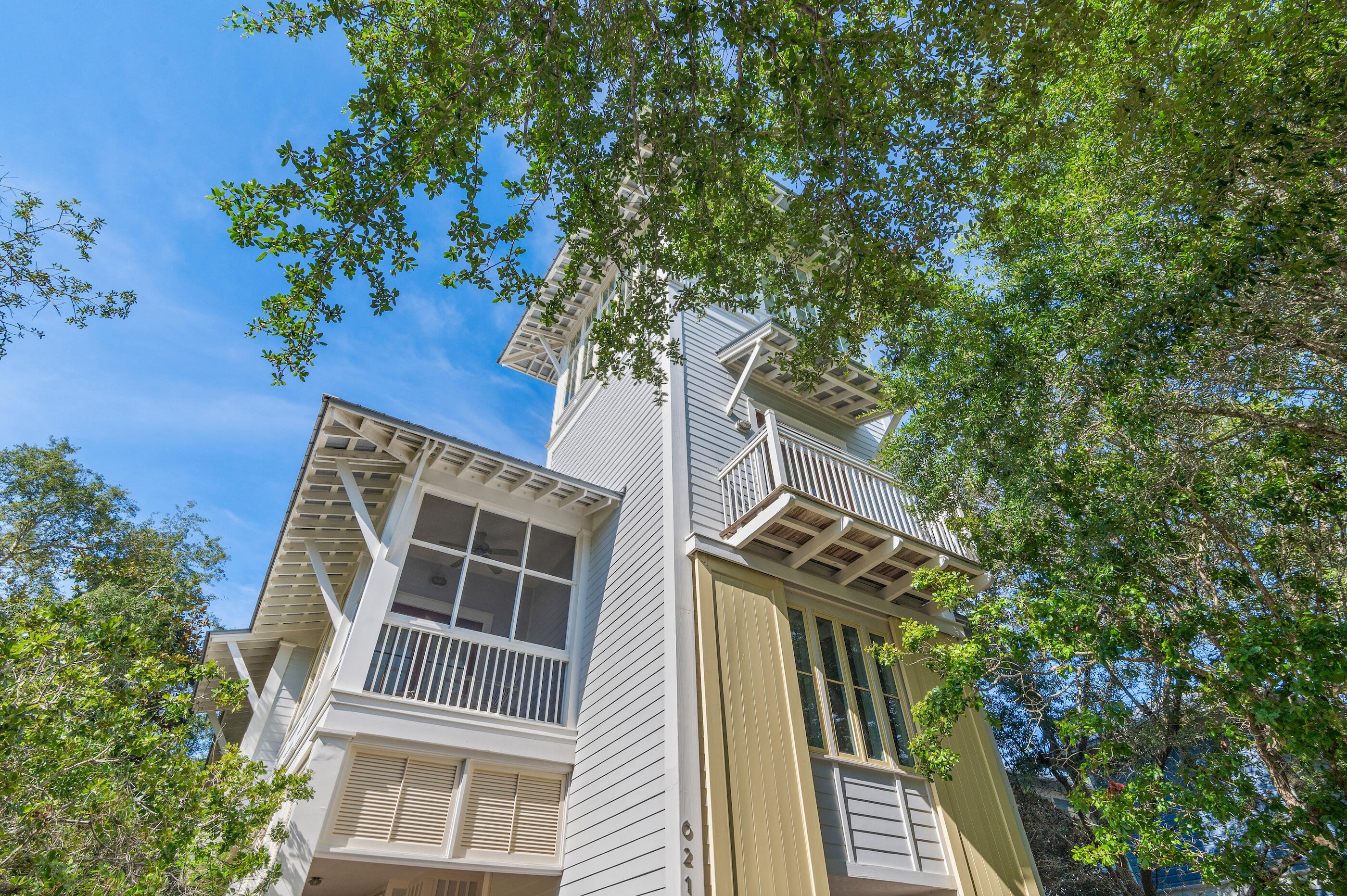 Located on Western Lake in coveted WaterColor Phase I, this architecturally stunning custom home offers rare Gulf and lake views from one of the tallest towers in the community—complete with wet bar and lounge. Just steps from the Boat House, Amphitheater, and a short walk or ride to the Beach Club, the home features a vaulted second-floor living space with wood ceilings and walls of windows, opening to a screened porch with fireplace. Highlights include Sub-Zero, honed marble, antique heart pine floors, and custom cabinetry. With 5 bedrooms, private office, multiple porches, and room for a pool, this elegant, light-filled home is perfect as a primary, second, or rental property.