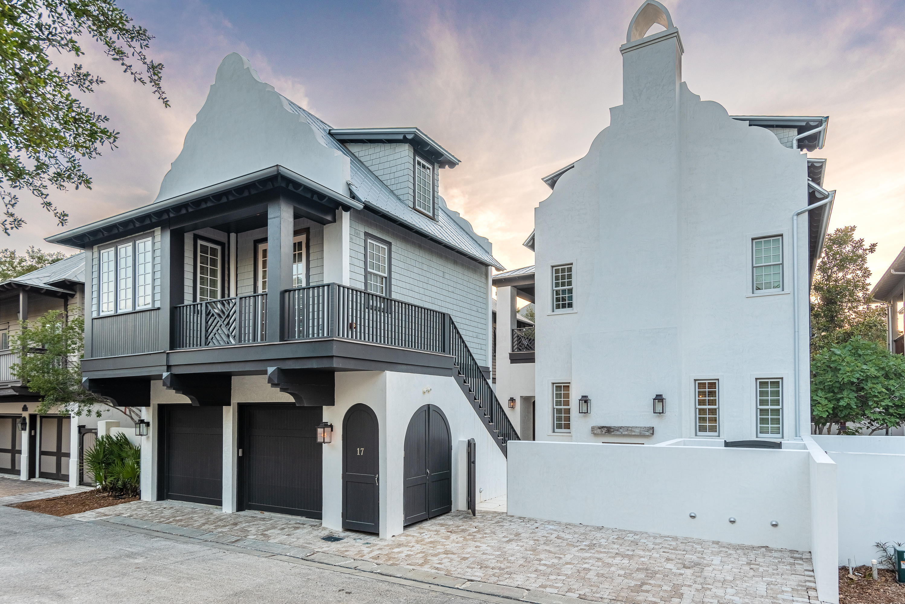 Exemplary coastal living can be found at 17 N Belize, located south of 30A in the heart of Rosemary Beach. This one-of-a-kind home, built in 2019 has been meticulously designed, creating an exquisite living space. Offering the convenience of the lifestyle town's pivotal location, the property is positioned perfectly for walking distance to all of Rosemary's most desired amenities, with the community pool only steps away. This home features 4,706 sqft of heated and cooled living space, including 7 bedrooms with 6 full and 1 half bathrooms. Constructed out of solid concrete, the home was masterfully designed to ensure longevity within a coastal environment. The spacious first level of the home consists of an open floor plan that is elegantly crafted with exposed wood beam ceiling accent, custom tile work, peacock paver floors, and a Venetian accent fireplace as the centerpiece.  A gourmet kitchen boasts custom cabinetry, quartz countertops, and environmentally conscious Italian Bertazzoni Appliances throughout.  The home's main bedrooms can be found on the second and third floors, providing ample space for family and guests.  Located on the second floor The master suite boasts ample living space with a lavish master bath that includes double vanity, rain shower with intricate tile work, with a large concrete soaking tub.

Across the courtyard, you will find a detached carriage house and a 2 car garage for additional parking and storage space. This carriage house is equipped with a full kitchen, living space, and bedroom on the main floor that offers guests their own private getaway. Follow the spiral staircase to a unique loft area with a full bathroom.
Nestled between the main house and carriage house is an unparalleled private outdoor living space, that includes a private wading pool with water features, multiple sitting areas, and an expansive outdoor fireplace.