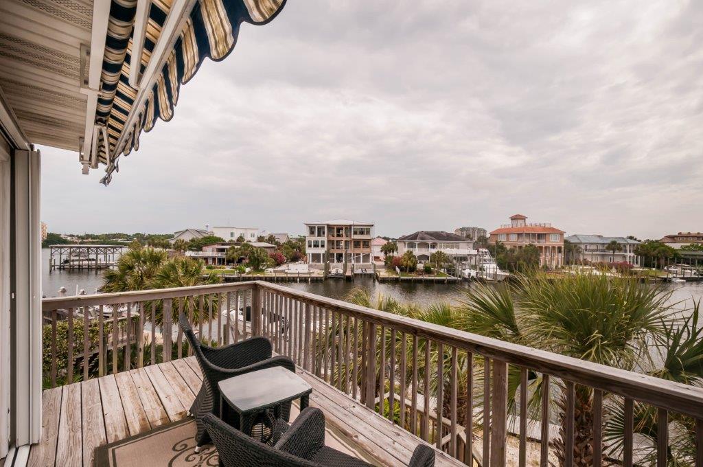 Fully updated Destin Florida waterfront town-home with 30' of dock with a boat lift. Located on the widest area of the canal on the Destin Harbor in prestigious Holiday Isle and only a 10 minute boat ride to East Pass or Crab Island, this home has it all! Kitchen was updated 2 years ago with granite counters, new stainless appliances and custom cabinets. The upper floor has 2 bedrooms, 2 tiled baths and French doors from Master Bedroom to the upper balcony with expanded Canal and Harbor views. Other improvements done since 2012 include a new central A/C unit, custom carpet in the bedrooms, double pane windows, decking and many more. Inside there is crown molding throughout the home and new interior doors upstairs.