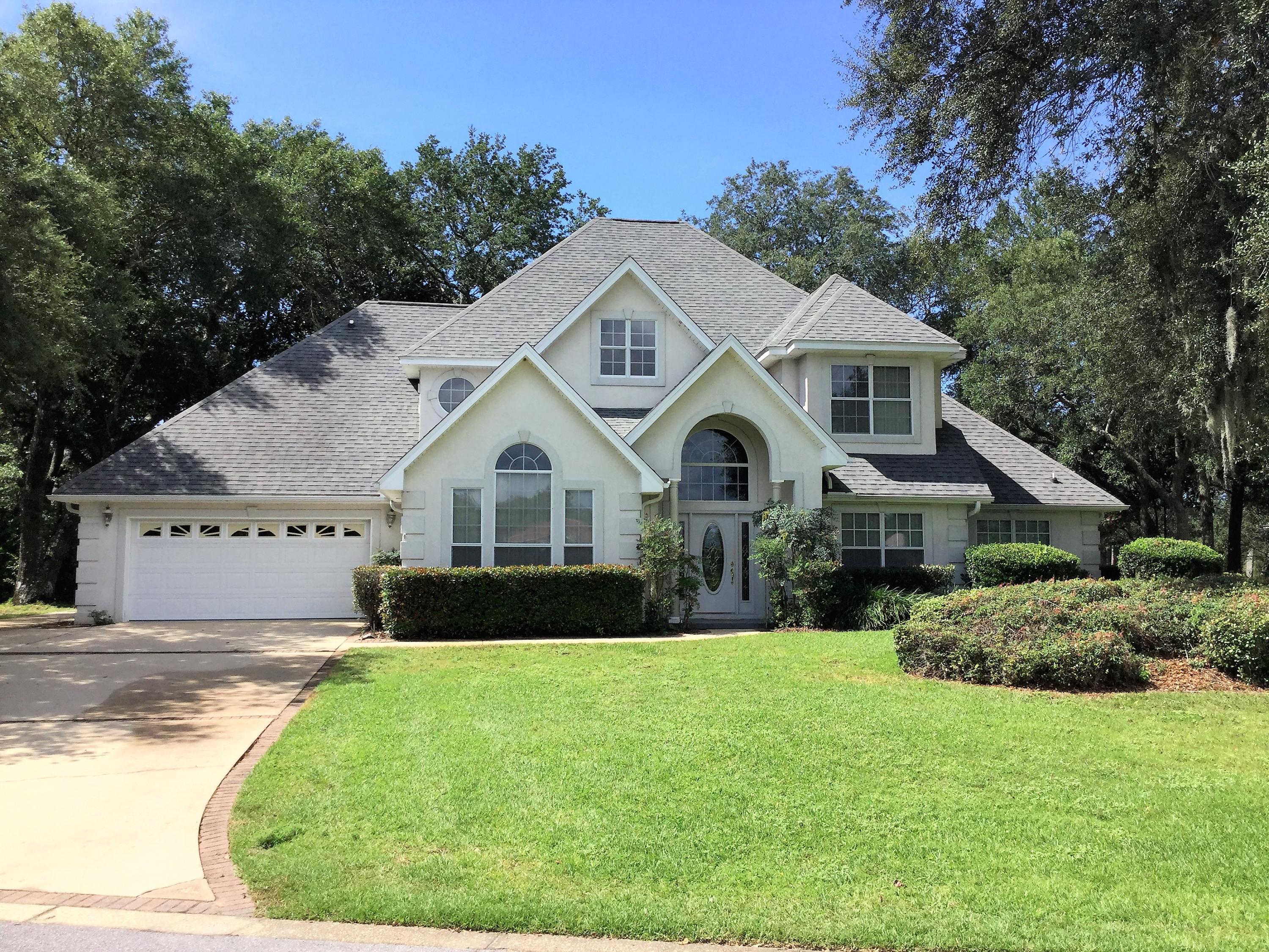 Spacious Executive home located in Gated community of Windward. Home backs up to Golf Course and is has Lake view from front. Upon entry you notice the open spacious plan with all tile flooring downstairs. To right is Office/Den area, left is Living Room, and Dining room. Through the large Entrance way open to Large Family room, ceiling soars to second floor, built in bookcases, gas fireplace and French doors that open to open patio. Kitchen with Breakfast room, JennAire stove and tiled floors. Laundry room to back of this area. Half bath also down stairs; Master Bedroom and Master bath are downstairs. Windows over look the golf course from bedroom. Master Bath has double vanities, Separate Shower, Tub and walk in closet. Two other Bedrooms are located upstairs and share a bath.