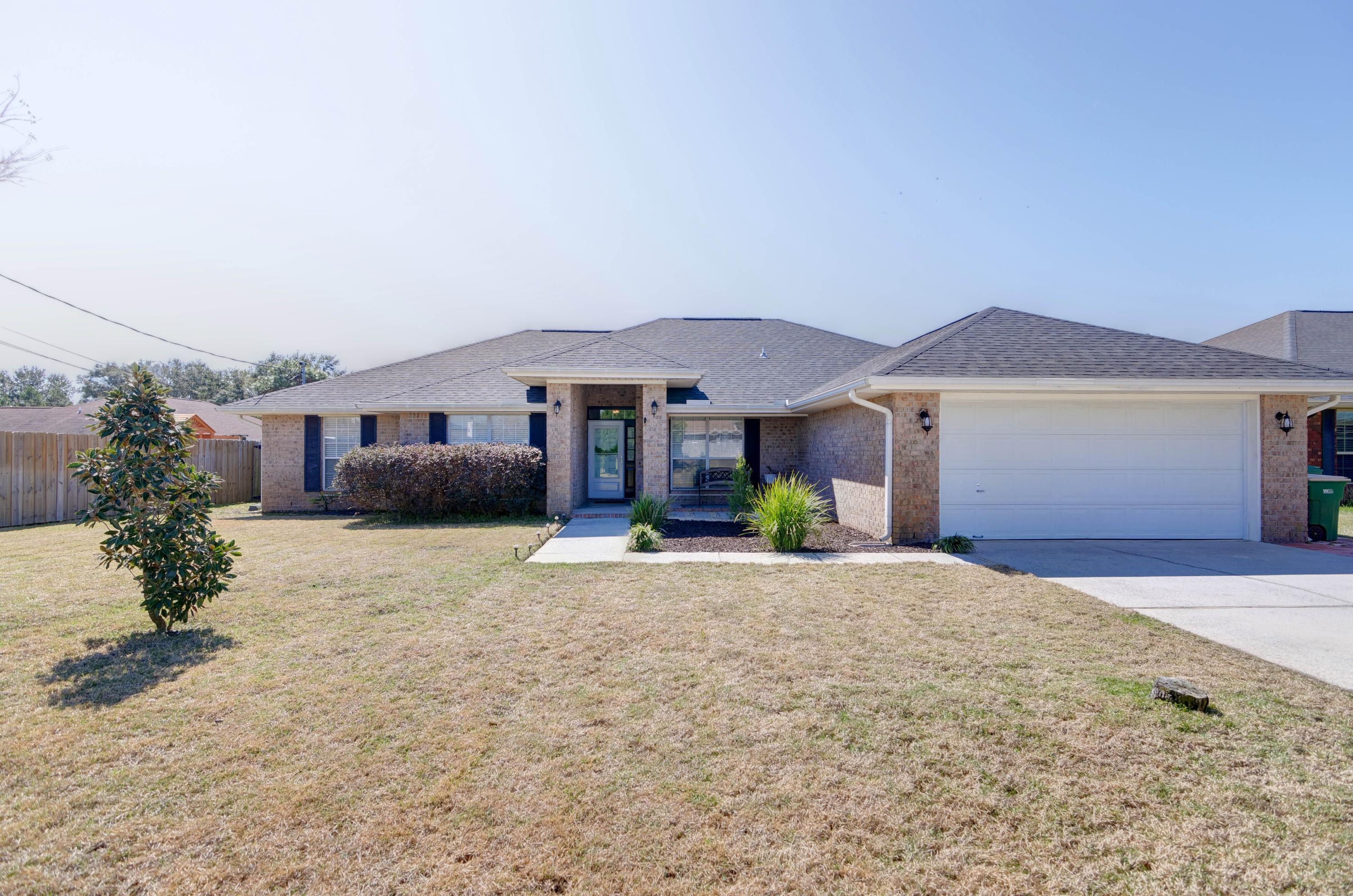 Welcome home to this stunning and spacious all brick east Navarre home! Featuring four bedrooms PLUS a formal dining room AND a massive bonus room with a sprawling backyard that has plenty of room for a pool, this is the gem you've been looking for! Located just minutes from Navarre's beautiful beaches and a short drive to Hurlburt Field, this property also has a great list of updated features. Walk up the front sidewalk and appreciate the well cared for landscaping, and enter inside to tile flooring extending throughout all the common areas. Appreciated the wainscoting in the formal dining room that's open to the large living room with a fantastic focal point wall. Enter into the upgraded kitchen and you'll find custom cabinetry (extended to allow plenty of storage and prep space!) with tasteful granite countertops and modern backsplash. You'll love the brand new appliances and fun colored pantry door. The split floor plan has a wonderful master bedroom with tile flooring and the owner's bathroom features two separate walk in closets, a soaking tub and separate shower, and a private water closet. The tiled laundry room is huge and leads to the nice sized two car garage. On the other side of the house you'll find the office/den/bonus room (which can easily become a 5th bedroom) through french doors, and the other three bedrooms which share a guest bathroom. Walk outside and you'll LOVE the massive fully fenced in backyard. There's plenty of room for a pool, or for any backyard activities you have planned. There is a storage building as well as a sprinkler system on a well. For peace of mind note the roof was installed in 2018, the HVAC in 2011, and water heater in 2014. The lawn pump for the sprinkler system was also just replaced this year. Check out the seller updates sheet for a full list of updates and schedule an appointment to come see your new home!