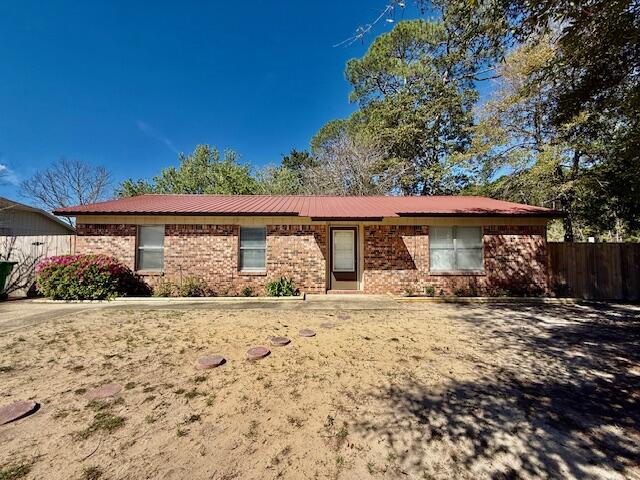 S/D = $1,895. PETS ALLOWED UPON OWNERS APPROVAL & W/ A NON-REFUNDABLE PET FEE. Welcome to this charming 3 bedroom, 2 bathroom home located in the highly desirable Niceville area. This single-story residence boasts a spacious open back patio, perfect for enjoying the Florida sunshine. The newly painted interior features tiled floors, crown molding, ceiling fans & blinds throughout. All electric! Large inside utility room w/ washer & dryer hookups off the dining area for added convenience. Situated on a corner lot, this home offers a large privacy fenced backyard, ideal for outdoor entertaining or simply relaxing. With a durable metal roof & brick exterior, this home is move-in ready & waiting for you to make it your own!