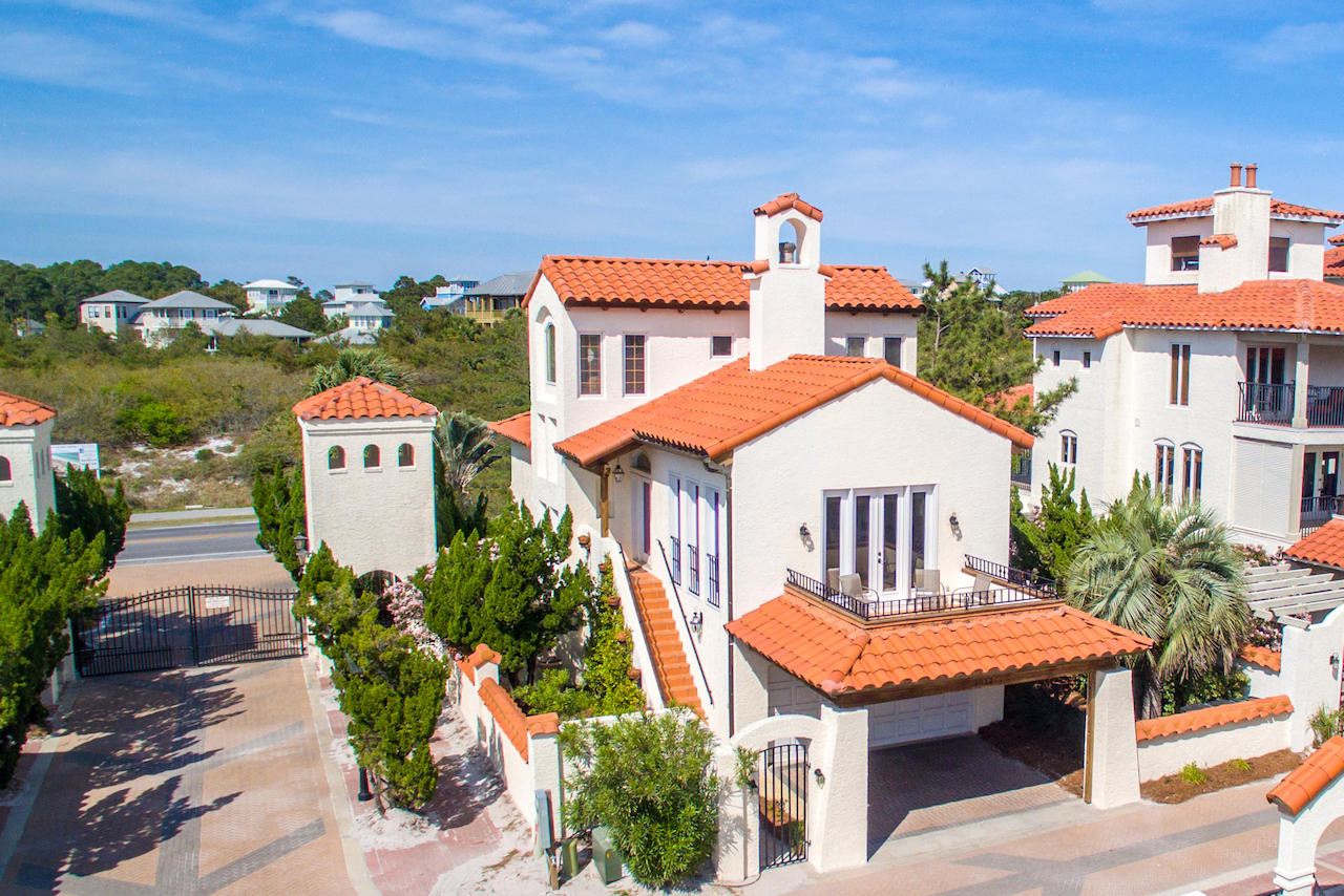 Italian-style villa just steps from a fabulous private walkover to the beautiful beaches of the Emerald Coast. This end-unit enjoys an ideal location in the small gated community of Vizcaya, on South Walton's beloved Highway 30A -- in just seconds you can be enjoying the beach, swimming in the large pool, or walking/jogging/biking along beautiful 30A. The 3-story home includes all the conveniences you will need to enjoy the beach lifestyle, whether it's as a family home or a rental property.
Both inside and out, the home reflects classic Tuscan architecture, from its red tile roofs to iron wrought details, tile floors, arched doorways, and vaulted ceilings. The main entrance and entertaining space is on the 2nd level, where a dual-sided fireplace can be enjoyed from both the dining. ...and living rooms. A balcony extends the living area for savoring the fresh sea air. A powder room for guests and the master suite are also on the main level. The master features a walk-in closet, attractive rustic tile in the bath, and a jetted tub with rain showerhead. A beautiful spacious wood stairway curves up to the third floor suite, the highlights of which are gulf views and another vaulted ceiling.

The first floor is equipped for enjoying the beach life. It includes 2 additional bedrooms with a shared bath, a spacious laundry/mud (sand) room, and a landing large enough to be a play room or sitting area. An outdoor shower and storage area for beach toys is just outside the first floor entrance. The home includes a 2-car garage and carport area for visitors. 

Vizcaya is located in Dune Allen, a highly desirable stretch of 30A, with the perfect combination of easy access to restaurants and entertainment, incredible natural beauty, and also peace and quiet. Buyer to confirm all information and specifications.