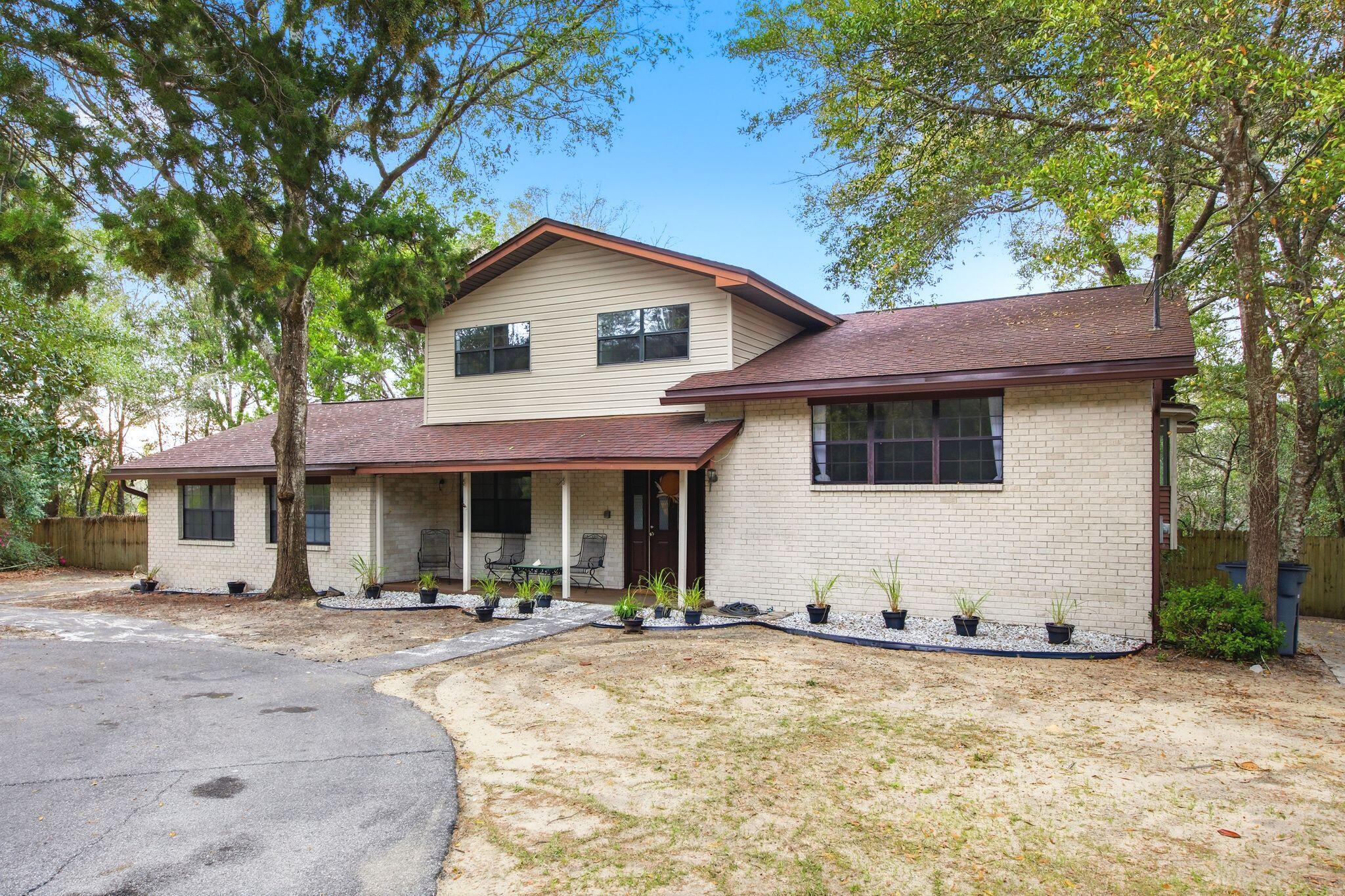 Rare opportunity in Valparaiso! Spacious 5 bedroom home with bay views, backing to undeveloped land & located less than a mile from the East Gate of Eglin AFB and recently appraised at $517,000. 

Imagine starting your morning on your private balcony overlooking peaceful natural surroundings & Tom's Bayou, with kayaks in the water & wildlife just beyond your backyard. This spacious home is bordered by the Eglin Federal Wildlife Reserve, with access to the bayou, offering privacy, scenic beauty & an outdoor lifestyle.

This split-level layout features 2 bedrooms & a flex room on the main level, while the upper level includes the primary suite & 2 additional bedrooms. Enjoy 2 living areas, formal dining room, eat in kitchen, sunroom, sun deck, balcony & plenty of room to park all your toys.