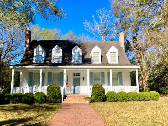 A RARE OPPORTUNITY! Beautiful residence on Circle Drive faces the lake in the DeFuniak Springs Historic District. Built in 1988, this gorgeous property features 3BR, 3BA, and a totally unique floor plan with original hardwood floors throughout, and a primary bedroom & bath on the main floor. You'll be amazed at the gracious scale and character of the spacious rooms, with crown molding, built-in bookcases, china cabinets,  and wood-burning fireplaces. Kitchen has stainless sinks, an island with breakfast bar, white cabinets, and a computer desk. All three baths feature meticulously maintained original tile. A million-dollar view of Lake DeFuniak from the huge front porch and a private backyard with mature shrubbery & a circular drive of red-brick pavers completes this one-of-a-kind listing.