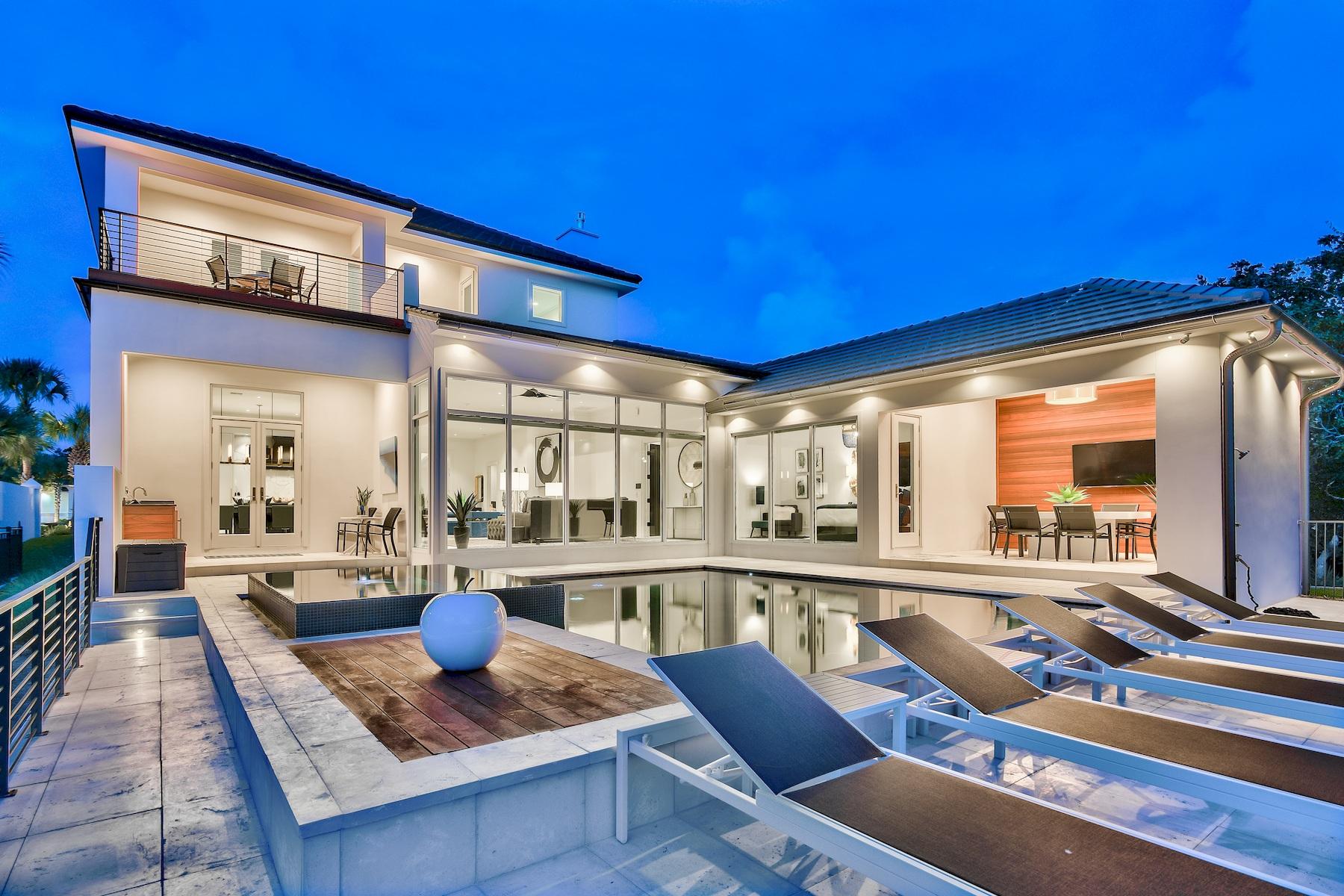 Modern elegance meets artful coastal contemporary design in this awe-inspiring beachside lake front residence newly completed in 2018 and ideally located two tiers off the Gulf of Mexico in the gated community of Destiny. This pristine contemporary retreat has been professionally designed, furnished and curated by Coastline Luxury Homes and has been masterfully configured featuring 5 bedrooms (including a pinterest-worthy oversized bunk room), 5 full ensuite bathrooms (3 of 5 bathrooms have double sinks) and a large open floor plan with clean lines and pristine lake vistas. This property is the perfect arrangement for a primary, secondary or rental focused end-use, economically designed for low maintenance living. The main entry is artfully arranged through an arabesque styled zaguan flanked by sizable custom built wooden 11 foot doors leading to a spacious open floor plan characterized by a wall of floor-to-ceiling windows spanning the South elevation allowing an abundance of natural light to cascade into the main living area perfectly framing a southwestern elevation defined by serene lake frontage, contemporary styling and gorgeous evening sunsets. The 18x30 fire rock paver flooring is consistent throughout the main floor straight through to the pool decking offering both durability and practicality for coastal living perfectly accentuating the sleek aesthetic through out the home. The designer kitchen is finely appointed and beautifully outfitted with floor to ceiling custom shaker cabinetry hand built by Amish craftsmen in Wisconsin, stainless steel appliances including a professional grade 6 burner thermador gas cooktop, Bosch dual convection ovens and hidden prep pantry complete with ample storage, a built-in wine cooler, sink and disposal. Dual custom-paneled full sized Thermador refrigerator & freezer allow for more than adequate fresh food storage. The kitchen also pairs utility with beautiful aesthetics including quartz countertops, a large island with a gourmet Kohler under-mount sink, 2 dishwashers, ice maker as well as ample storage in the adjoining hand crafted cabinetry. The home also has a whole house water filtration system.  The sprawling rear patio which includes a bar area with outdoor refrigerator and sleek reflecting pool and adjoining spa are perfect for entertaining and features both covered and uncovered living space all of which is focused over the fabulous pool deck adorned accented with Brazilian hardwood which opens freely to the expansive lake views. 

The Master suite occupies it's own private wing and features gorgeous decor, beautiful views over the pool & lake area through sleek floor to ceiling store-front glass, large walk-in closet with built in shelving as well as a spa like master bath complete with dual vanities, private water closet, free-standing soaking tub and large walk-in shower surrounded by a suspended glass enclosure, pebble flooring as well as floor to ceiling tiled accent walls. Other notable features of this property include: custom designer lighting, sleek distressed black hardwood flooring on the second level.  Two of the three bedrooms upstairs have access to the back balcony that overlooks the lake.  There is a security system with multiple surveillance zones, custom window treatments including electronic window shades in every room & exterior plantation shutters as well as a two-car garage with third golf cart stall. This home is the ideal property as it is fully transitional & highly functional as both a primary or secondary retreat as well as a top producing luxury vacation rental. Centrally located, this property is in very close proximity to beach access as well as the exclusive amenities offered in Destiny which include a private fitness facility, community clubhouse, large community pool & spa, professional tennis courts and proximity to world class shopping, dining and entertainment.