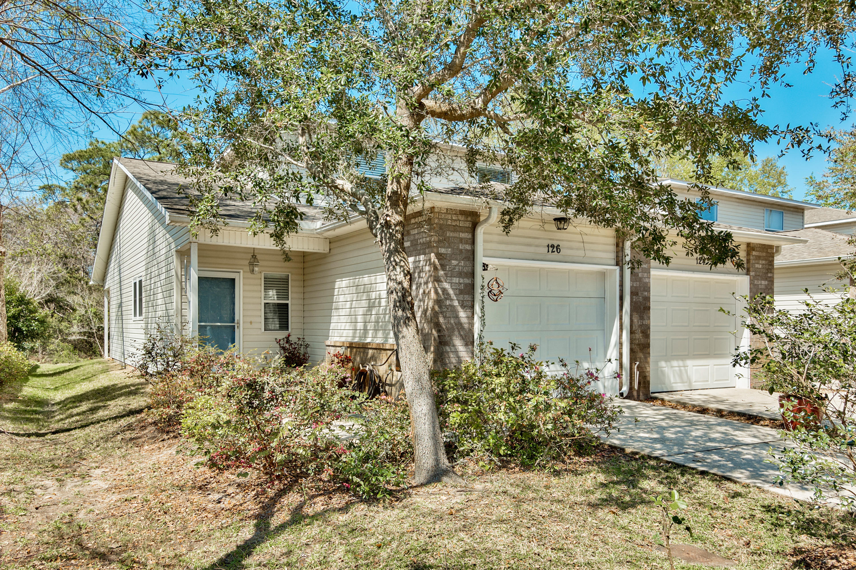 Great END UNIT on a quiet cul-de-sac surrounded by nature. Only 2.2 miles west of Hurlburt Field. Open floor plan with high ceilings. Spacious kitchen with an island, stainless steel appliances, Corian countertops, plenty of cabinets and a pantry. First floor master bedroom with walk-in closet. Separate tub and stand-up shower in master bath. Storage area under stairs. Two bedrooms with large closets and a full bath on the second floor. Upgraded higher-end ceiling fans. Energy efficient home with good insulation and with a storm door and pull down screen. 20x20 Porcelain tile throughout the first floor. Indoor laundry hook-ups on first floor. 1 x car garage & generator transfer station in garage. Private covered front and back porch. HOA fees cover insurance and lawn care.