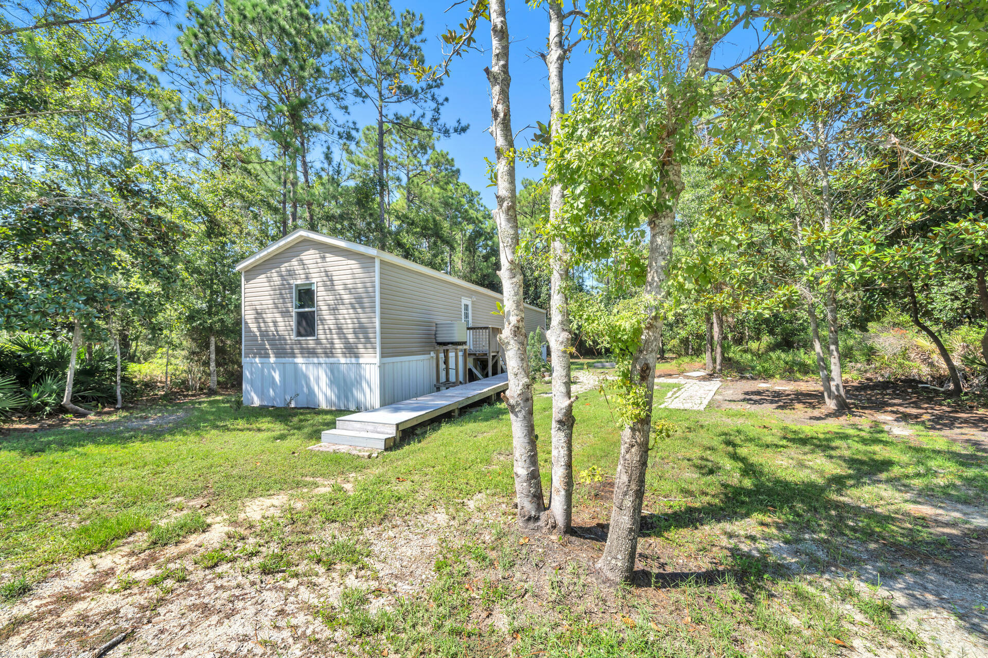 Affordable living in the heart of Santa Rosa Beach!! 3BR/2BA home built in 2017, on peaceful private wooded lot. Very clean and ready for the next owner! This listing includes the vacant lot next door for a deal that can't be passed up!! This parcel is situated close to all that draws people to beautiful Santa Rosa Beach - 8 minutes to the beaches of 30A Ed Walline Regional Beach Access; less than 5 minutes to the Cessna Landing/Hogtown Bayou public boat launch; schools all within 20 minutes drive; 15 minutes to Sacred Heart Hospital of the Emerald Coast; and close to all shopping and dining! Call me today for all the info on how you can secure this low priced property as your home or investment!