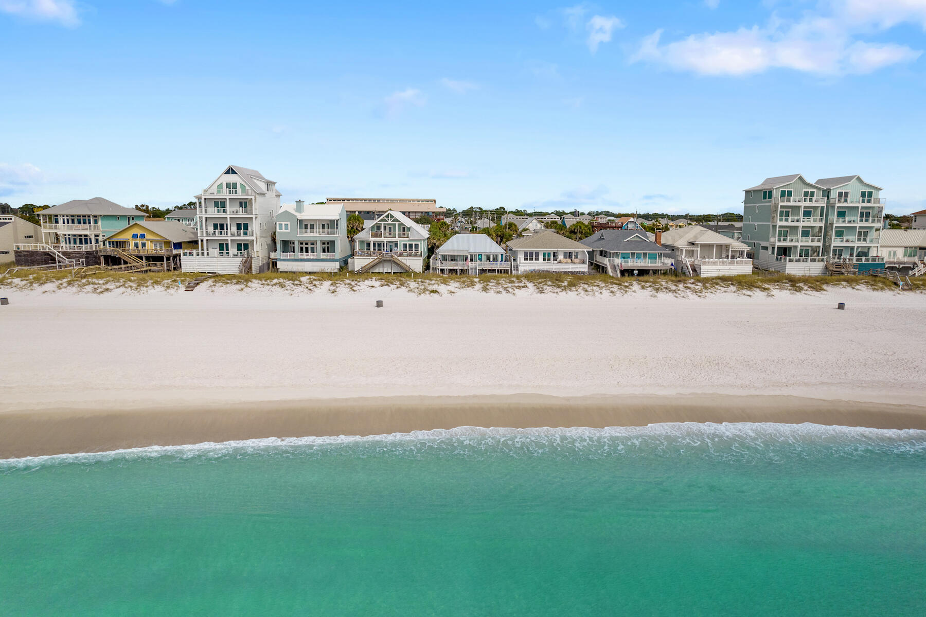 LOCATION! LOCATION! This 3-bedroom, 3-bath Gulf-front haven in Panama City Beach is a must see! Meticulously cared for, this beach house showcases 50 feet of sugar white sand frontage. Every detail reflects unparalleled care, from the decadent interior to the immaculate grounds. Owners recently updated the home with a brand new metal roof and paved driveway with gated entrance. Immerse yourself in luxury and coastal elegance while still allowing yourself to relax and unwind. After a day of sun-soaked bliss, kick off your flip-flops and unwind in your private hot tub, surrounded by the soothing sound of the waves.