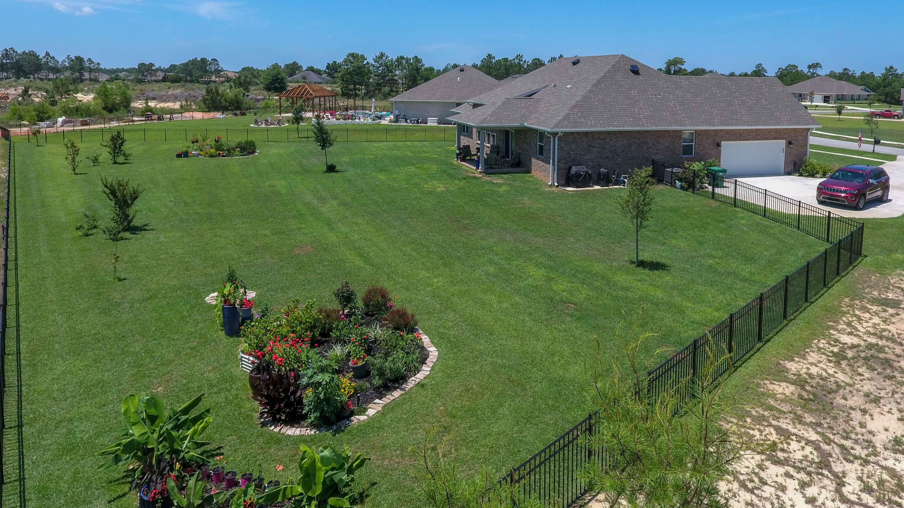 This pristine 4-bedroom, 3-bath home sits on a spacious .70-acre lot in a quiet cul-de-sac. The fully fenced backyard offers plenty of space to add your own private pool. Inside, you'll find luxurious LVP flooring, 12-foot ceilings in the living room and foyer, and abundant natural light from the many windows in the sought-after Lilac floorplan. The kitchen features stainless steel appliances and quartz countertops. Plus, there's no carpet throughout the house! The vacant .66 acre lot next door is also available to purchase and can be significantly reduced for buyers who want to ensure no future construction adjacent to their new home.  DOUBLE LOT OPPORTUNITY = 1.36 ACRES! Windswept Amenities include a clubhouse with pool, basketball courts, tennis courts, pickle ball courts, a pavilion and grill, weekly food trucks, fishing, nature trails, plus so much more! Reach out to Listing agents for additional amenity information.
