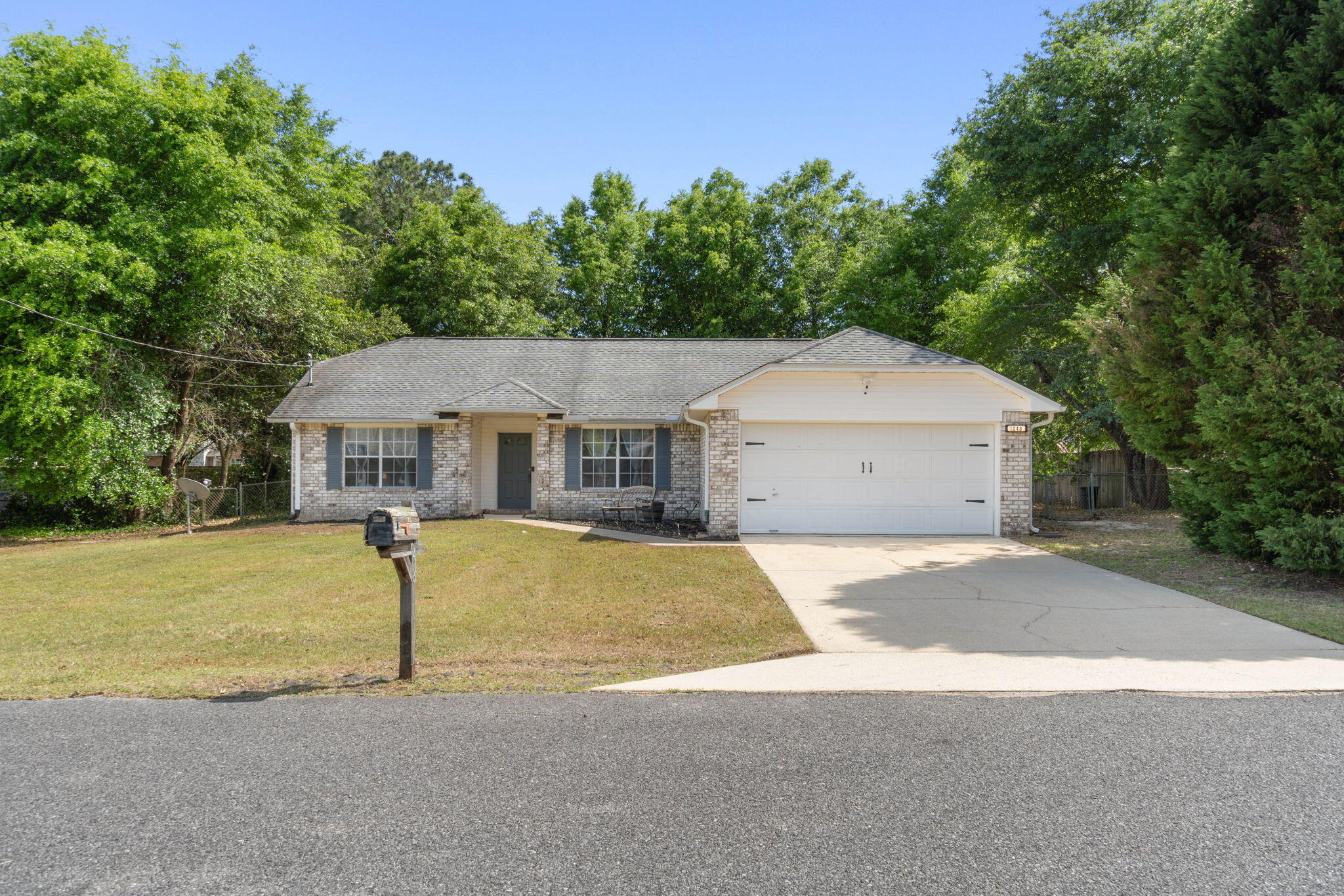 Welcome to this move in ready home on a large FLAT lot SOUTH of I-10 in Crestview! Appreciate this split floor plan featuring the owner's suite on one side of the house and two additional bedrooms on the other with a flex space open to the great area with wood look tile throughout! The bright kitchen offers a convenient center island as well as a breakfast nook with brand new stainless steel appliances! The owner's suite features a bathroom with TWO walk in closets as well as a double vanity and linen closet. On the other side of the house you'll find the additional two bedrooms with ample closet space and a shared full bathroom as well the interior laundry room that leads to the two car garage. There is a sliding glass door that leads out to the large and flat fenced in backyard where you'll find a back patio leading to a fantastic fire pit area where you'll love relaxing and entertaining! The roof and HVAC system were replaced in 2014 and the water heater is brand new installed in 2024. Welcome home!