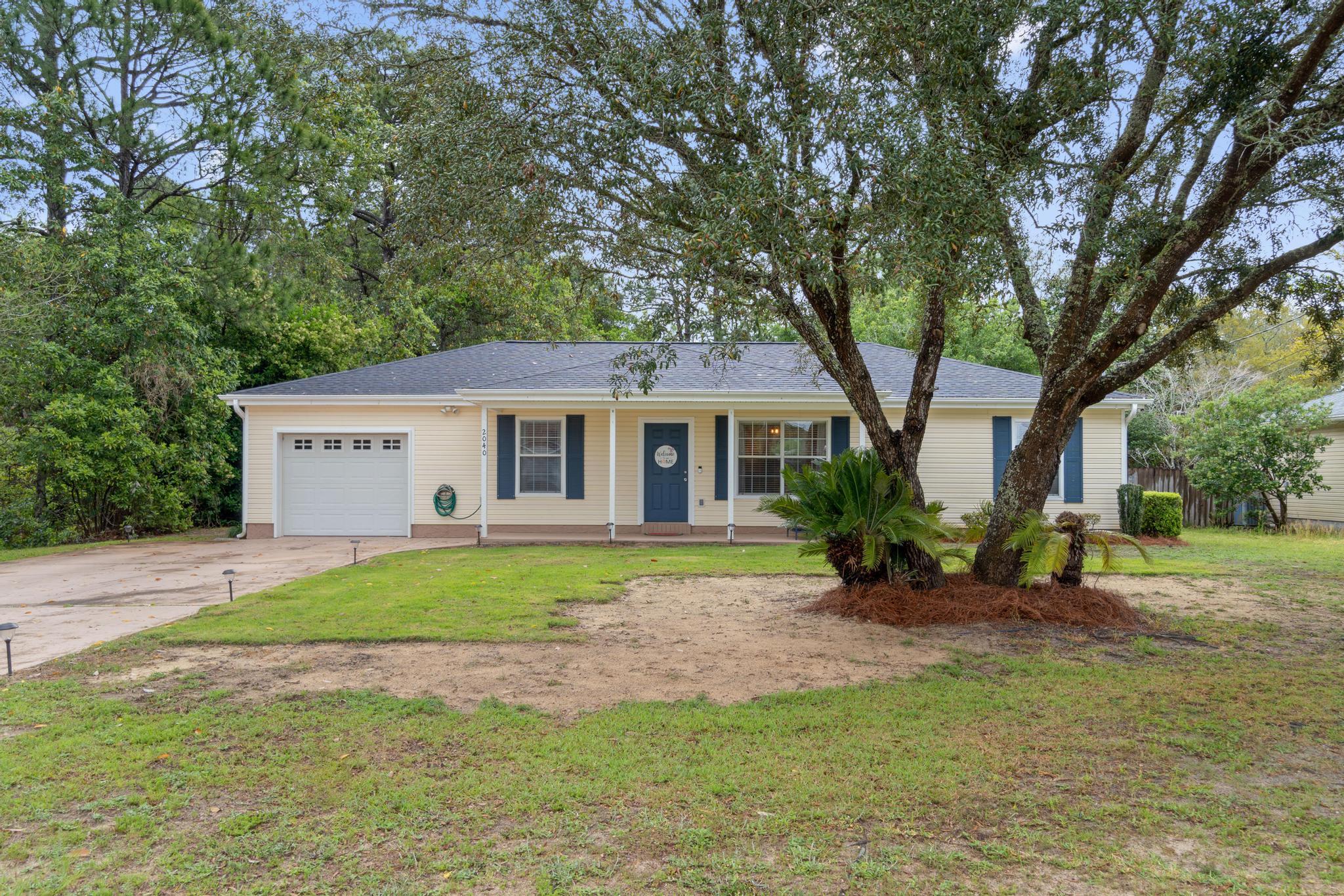 Welcome home to this beautifully updated 3 bedroom, 2 bath ranch style home in the heart of Navarre. Walking distance to local schools and located on a spacious 0.42 acre lot you're going to love this home featuring a great list of seller updates including a new roof just installed last month (March 2022)! Have additional peace of mind with an HVAC installed in 2016 and a new water heater in 2017. Pull up into the oversized driveway and adore the sprawling covered front porch and mature oak trees. Inside you'll find laminate flooring extending throughout (with tile in the kitchen, bathrooms, and laundry room), tasteful paint, knock down textured ceilings (no popcorn!), and a trey ceiling in the living room. The dining room has a  large cut out to the living room creating a nice open space! The gorgeous kitchen was remodeled in 2018 and features granite counters, stainless steel appliances, a custom built in coffee bar with wine cooler, farmhouse style sink and hardware, and a pantry. From the kitchen and before you get to the one car garage you'll find a great sized mud room space with additional shelving that leads to the enclosed space for the interior washer and dryer. The split floor plan has a great sized master bedroom that also features a trey ceiling, as well as a walk in closet, and a well appointed bathroom with an extended granite countertop. The other two bedrooms are located on the other side of the house and are nice sized with ample closet space and a shared full bathroom between them. Outside you'll find a great covered back patio and a spacious fully fenced in backyard complete with an outside storage building. Don't miss out on this gem close to Navarre's gorgeous beaches and a short drive to Hurlburt Field! Ring doorbell and exterior cameras will convey.