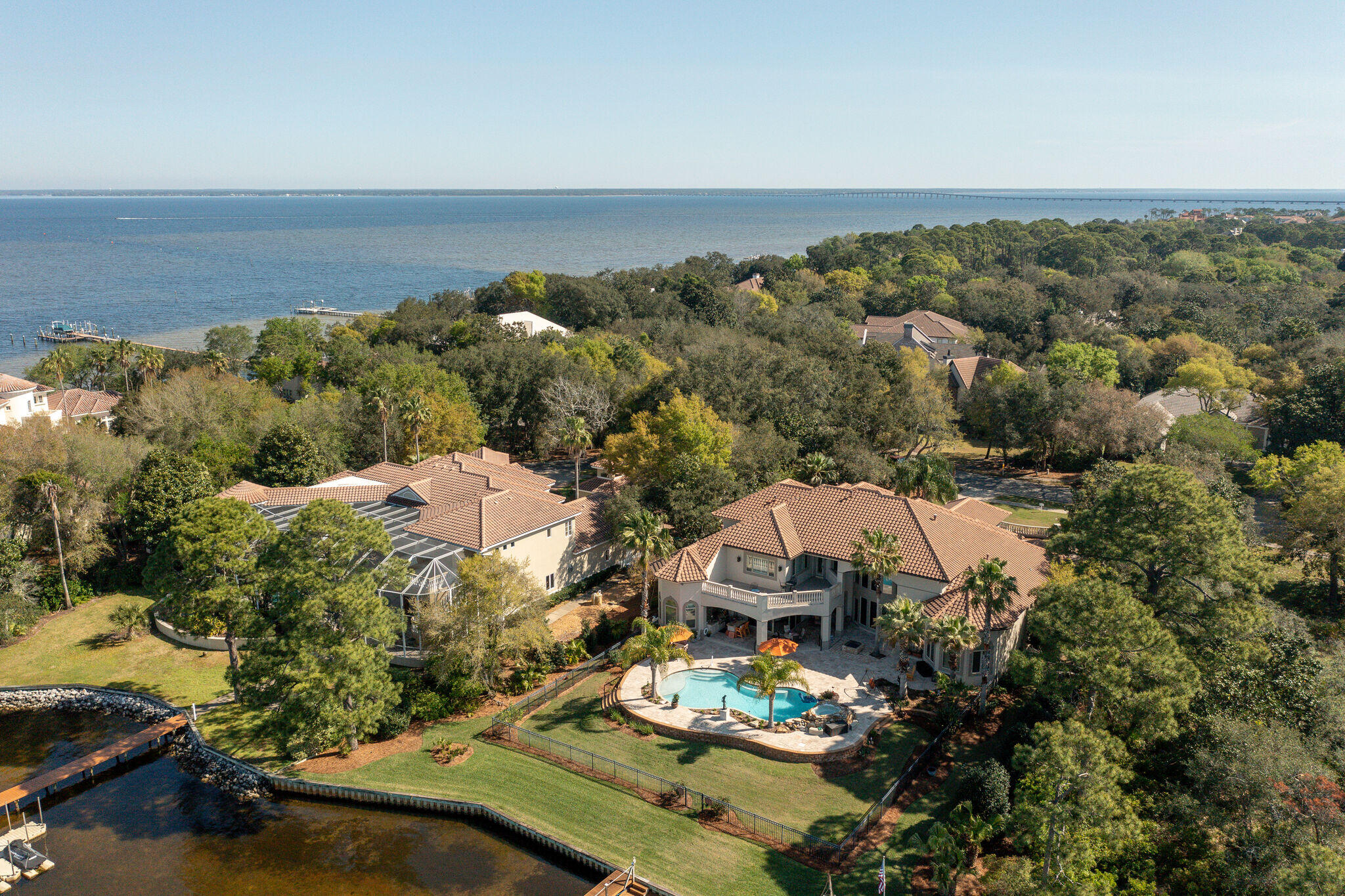 Rare opportunity to own a luxury residence offering waterfront living and boating at it's best! Situated on wide, deep water within the gates of desirable Kelly Plantation, on a lot graced with mature live oaks and magnolias, with 145 feet of bayou frontage. Meticulously designed for gracious entertaining and family living, with no details overlooked and a well designed floor plan that utilizes every inch of space. Fabulous curb appeal, with a brick paver circular drive and porte-cochere and gorgeous hand forged double wrought iron doors opening into a grand foyer, living room with soaring 23 foot coffered ceilings, the adjoining formal dining room and a handsome study/library with custom mahogany built-ins. The luxurious master wing is to the left...and is nothing short of
opulent, with a spacious waterfront bedroom, two large walk-in closets, sumptuous bath with large double vanity, private water closet, huge walk-in shower, soaking tub. Just off the living area is the spacious, open concept heart of the home....with a large casual dining area, a kitchen that is just fantastic with tons of custom cabinetry, gleaming granite counters, a huge breakfast bar, large walk-in pantry, upgraded appliances including a gas cooktop and a new dishwasher, and a leisure room with sliding glass pocket doors opening on a 45 degree angle onto the outdoor living area. Two additional ensuite guest rooms are on the first level as well as a generously sized laundry center. On the second level is a large loft area, perfect as a den or game room, two ensuite guest bedrooms, and a large 12.5'x 29' heated and cooled storage room. Finely appointed with custom features throughout including spectacular mantle and fireplace surround, deep crown molding, travertine floors, coffered ceilings, recessed and art lighting, designer lighting, faux finishes, custom cabinetry and built-ins and so much more. Exterior recently painted. 
 Everyone will love the outdoor living area, with summer kitchen, pool with stacked stone water feature, private dock with boat slips and watercraft lifts. Dockage will accommodate a large vessel. The open bay is only three lots away and it's just a short boat ride to Crab Island, Destin Harbor and the Gulf.  Furnishings are negotiable.  For added peace of mind, a 65 KW generator powers the entire home in case of power outage. If it's waterfront living you're searching for...you've found it!