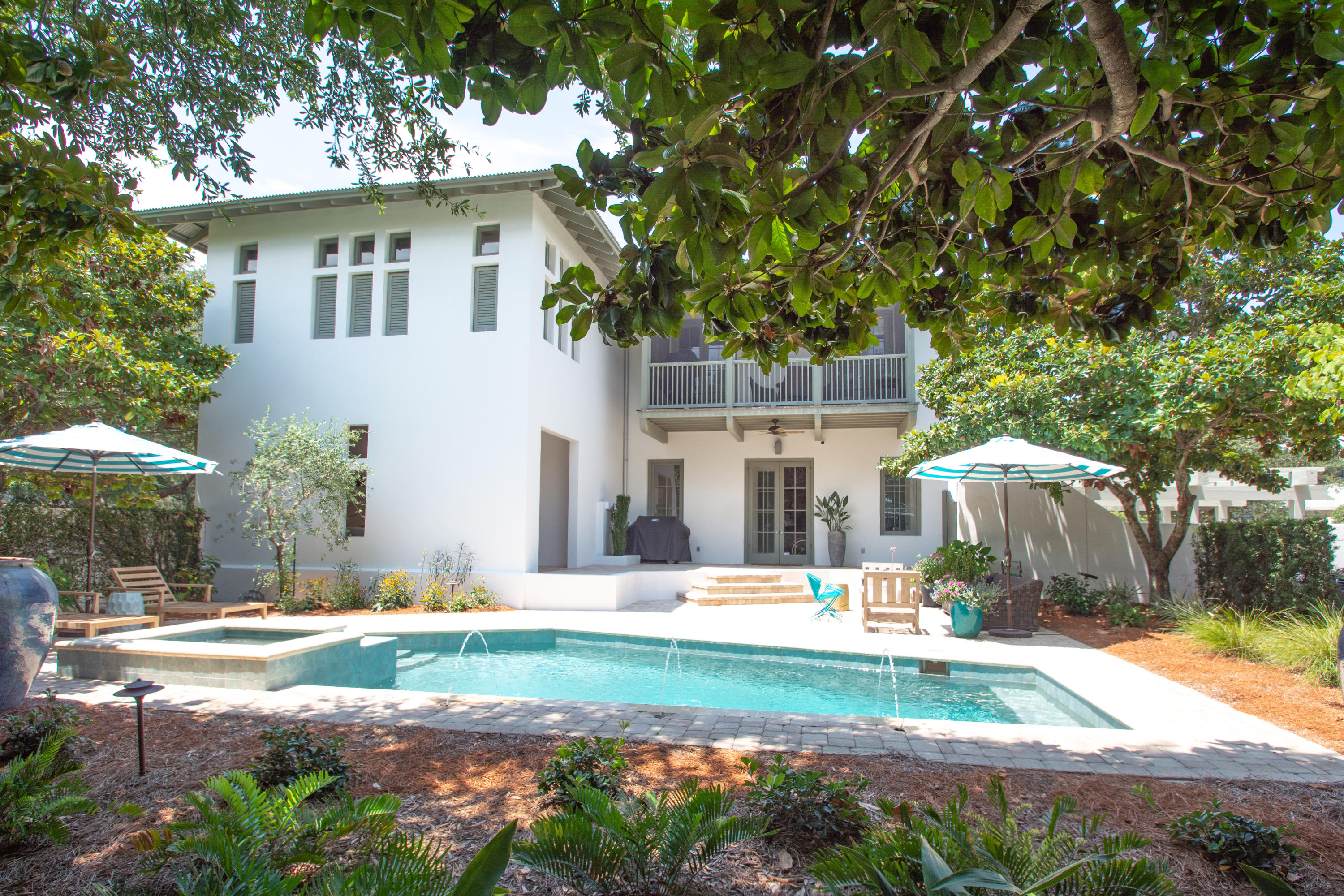 Prominently positioned overlooking East Long Green Park, this Rosemary Beach Retreat boasts broad views from the 2nd floor. A New Orleans style entry from the park through an outdoor covered loggia leads to the spacious private courtyard with a resort size pool and hot tub. Level one hosts three guest bedrooms. A Jack and Jill arranged bath is shared between two of those bedrooms and the 3rd has an ensuite bath. The laundry and an outdoor shower also occupy this level with a light-filled hallway connecting them. The 2nd level hosts the living area and the master bedroom with ensuite bath adjacent to a balcony above the courtyard. This floor also enjoys a multi-windowed office and half bath. The office may convert to a bunk room.