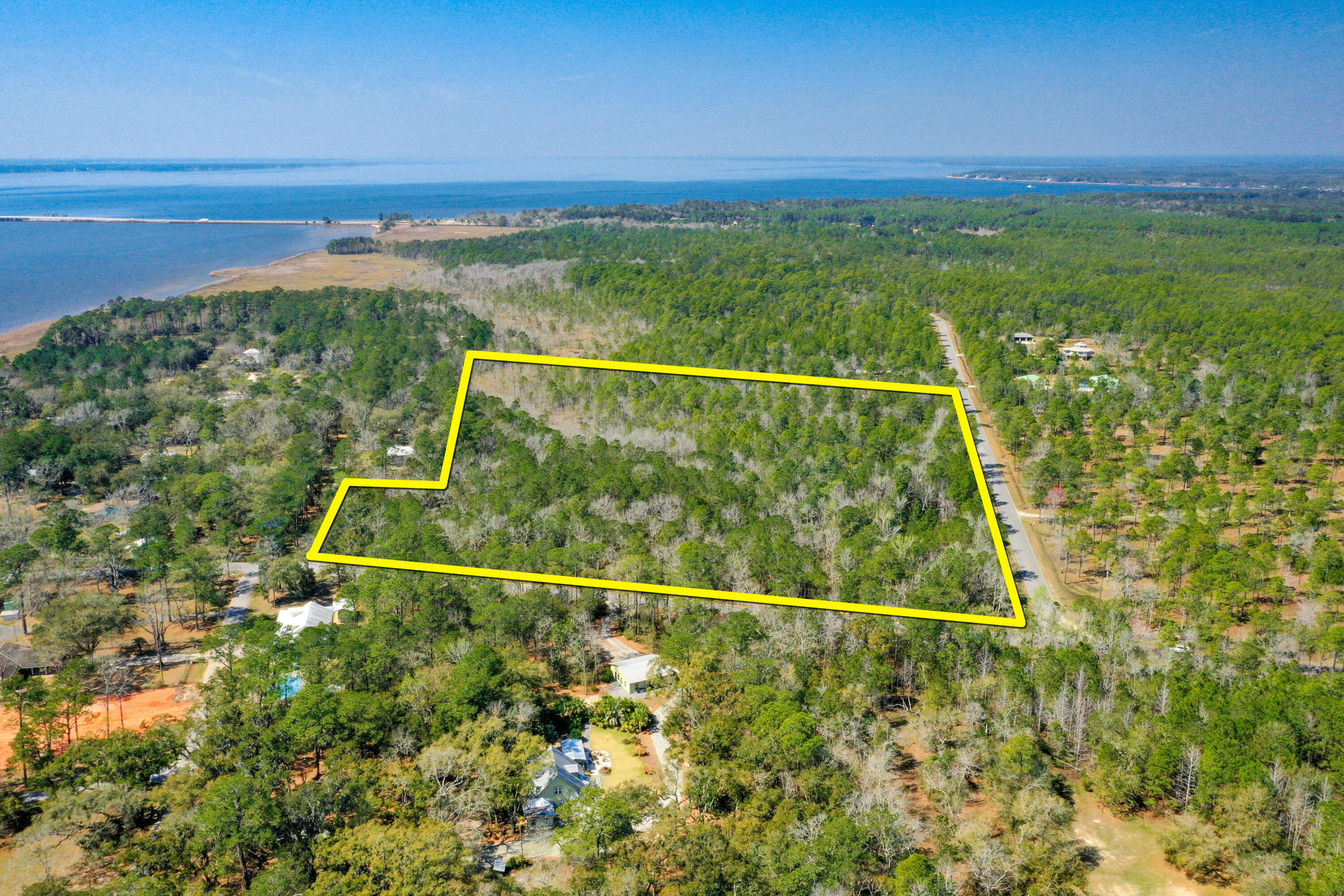 Just Listed!  (7) contiguous prime parcels totaling approximately 12-acres located across from the Choctawhatchee Bay and oriented between two street corners at Jolly Bay Road and Fluffy Landing Road. This assemblage offers convenient access from Highway 98 in South Walton County, as it easily accessible via paved County maintained road at the new traffic light at Jolly Bay Road and the newly expanded bridge and Highway 331; thus, allowing for a multitude of residential uses only minutes away from the gorgeous beaches of South Walton County in Santa Rosa Beach, Florida.  (3) of the (7) contiguous parcels are located within a community known as Jolly Bay Acres, which not only offers a quaint picnic area and park setting on the shoreline of the scenic Choctawhatchee Bay, but also will... allow the future owner(s) the use of (3) assigned boat slips.  The Walton County zoning (aka future land use) is known as Rural Residential.  This opportunity would permit a host of viable and marketable residential site planning scenarios, perhaps including, but not limited to the larger acreage being developed as a private neighborhood, while the (3) single-family platted lots yield individual new houses; or the druthers of the buyer may be to enjoy this gorgeous expanse of native old Florida property as a private family compound in a very tranquil, serene setting along the flourishing Emerald Coast of Florida. Please inquire for further details.