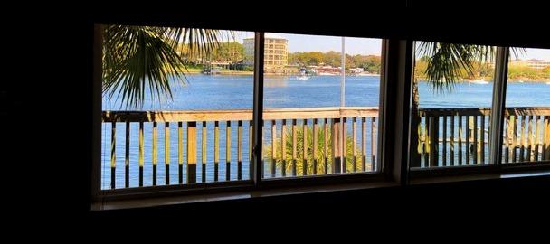 THIS IS IT!!! #BOATLIFE #BEACHLIFE PRIME waterfront location with assigned deep water boat slip, beach area and deck to view the fireworks and more!!! This waterfront AND waterview unit sits on the Intercoastal Waterway & allows incredible views from the living room, kitchen, bedroom and deck! The kitchen and living room are one large open space. Neutral tile floors throughout make this condo easy to maintain. Your ''backyard'' includes a sandy beach w picnic tables, fish cleaning station, boat launch and dock w assigned slip. Plus you are only steps away (.2) from the county gulf side beach access. On site laundry is available or you can install a stackable in one of the unit's storage closets. No worries here with concrete block and brick construction and 15 ft above sea level!