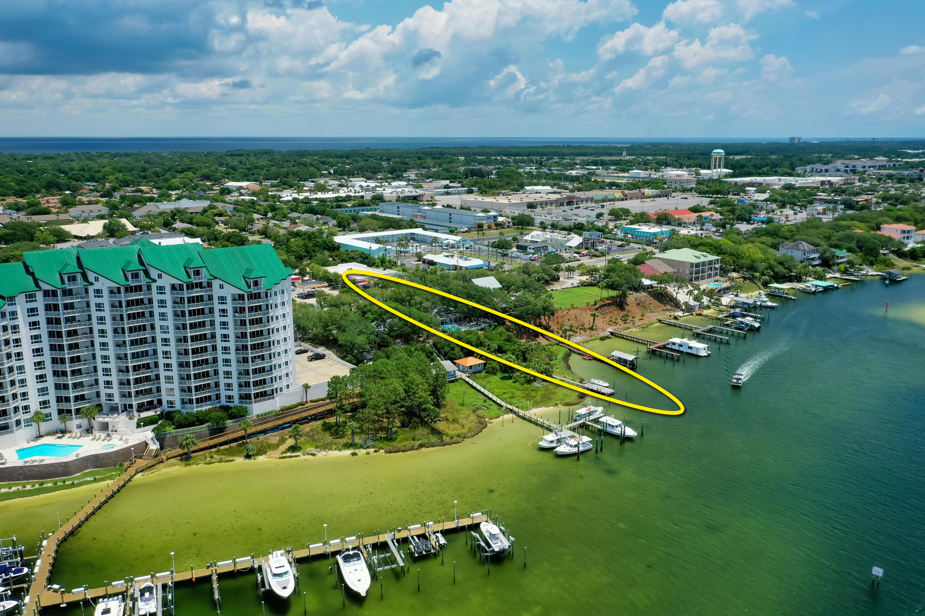 Welcome to 702 Harbor Boulevard, a legendary property graced by moss-filled, gorgeous Southern Oaks, and expanding over .50 acres on a high bluff overlooking the Scenic Harbor of Destin, Florida!
Never listed in its history, this generational home is a quintessential homestead now available for a new family to enjoy as a coastal retreat.  The home features gorgeous Heart Pine, high ceilings, separate guest cottage, and a pool with a stunning view corridor across the harbor.  This fabulous property contains 121' on the deep-water of the harbor, thus offering deep-water boat slips with the capability of mooring large vessels in the virtual wildlife sanctuary of this estate's backyard.  The infrequent offering of such a unique, charming property makes this listing extremely... special.  The location is superb, as the walkability to all the commercial establishments in the harbor district of Destin, Florida, including the world-famous Harbor Docks restaurant, which is nearly adjacent to the property, accommodate a phenomenal coastal lifestyle. The existing structures are being sold in their "as is, where is" state and condition.