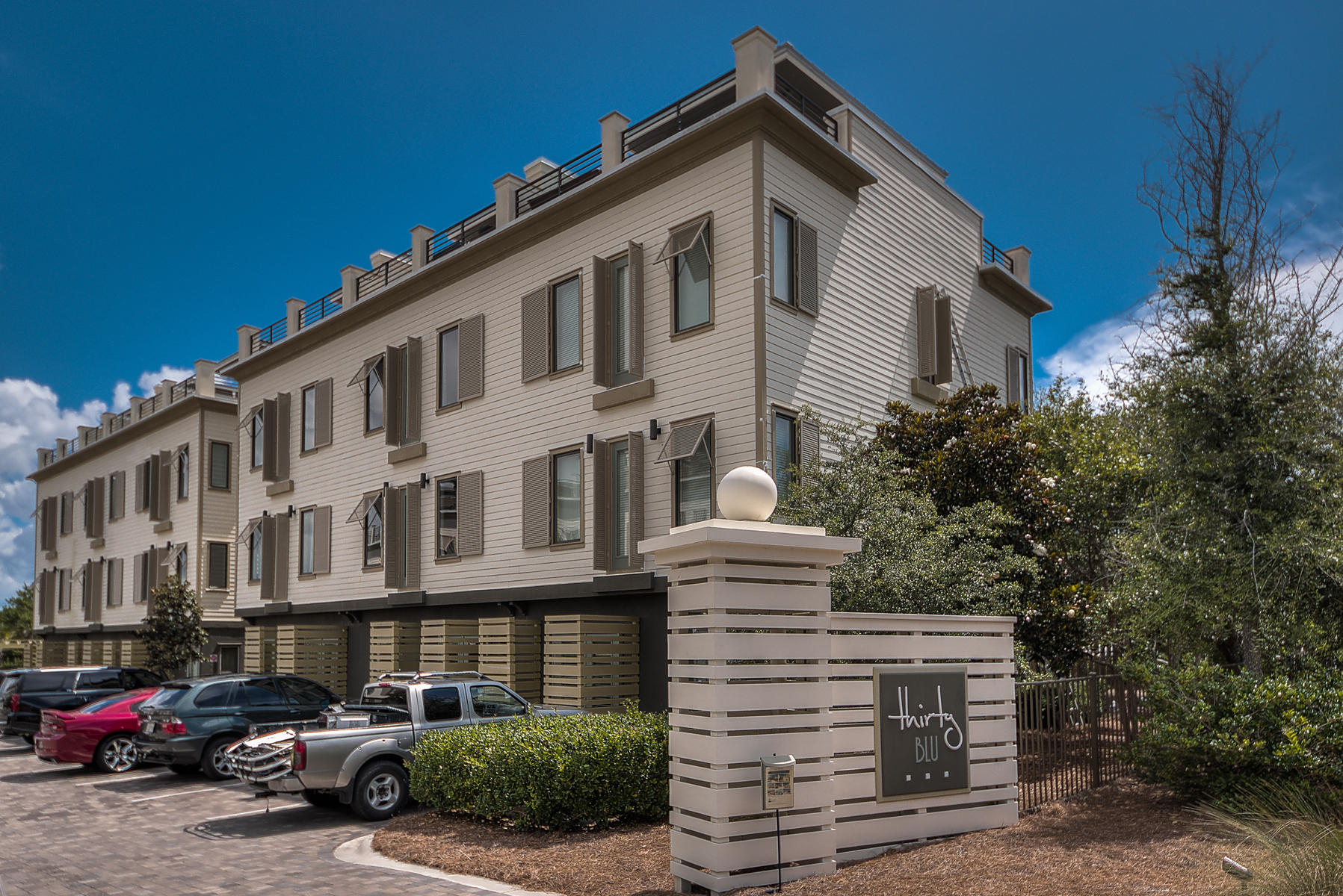Thirty Blu is an upscale development comprised of twelve townhomes that enjoy superb amenities and utmost attention to detail. These residences are situated directly on the north side of Blue Mountain Beach, across from Blue Mountain Road and its many nearby beach accesses. Unit 10 is an impeccably maintained unit and is located steps from the pool & amenity area. Inside you will find two separate living areas as well as a spacious kitchen with granite counters, stainless steel appliances, an enclosed pantry and large center island. Hand-selected interior finishes include custom paint and tile schemes, detailed molding, hardwood floors throughout (except on the ground floor and in the baths) coastal-contemporary lighting and more. The fourth-floor roof-top terrace is completely unique to the Blue Mountain Beach area and the perfect spot for sunset, as well as sunbathing throughout the day. The pool is a beautiful amenity with tabby concrete, covered cabanas, and top of the line gas grill for the community's enjoyment. There is no comparison to the location, finish, and amenities for this price point along 30A.