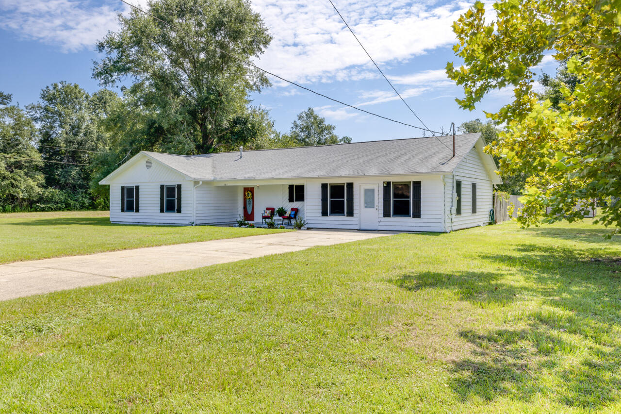 This home with three bedrooms and two and a half bathrooms features a bonus room that has its own entrance, a cozy fireplace in the living area, a covered back porch as well as a separate building in the backyard. The home sits on 1.38 acres with yard space for outdoor activities. Roof 1/2026 Water Heater 1/2026.  Call today for a showing.