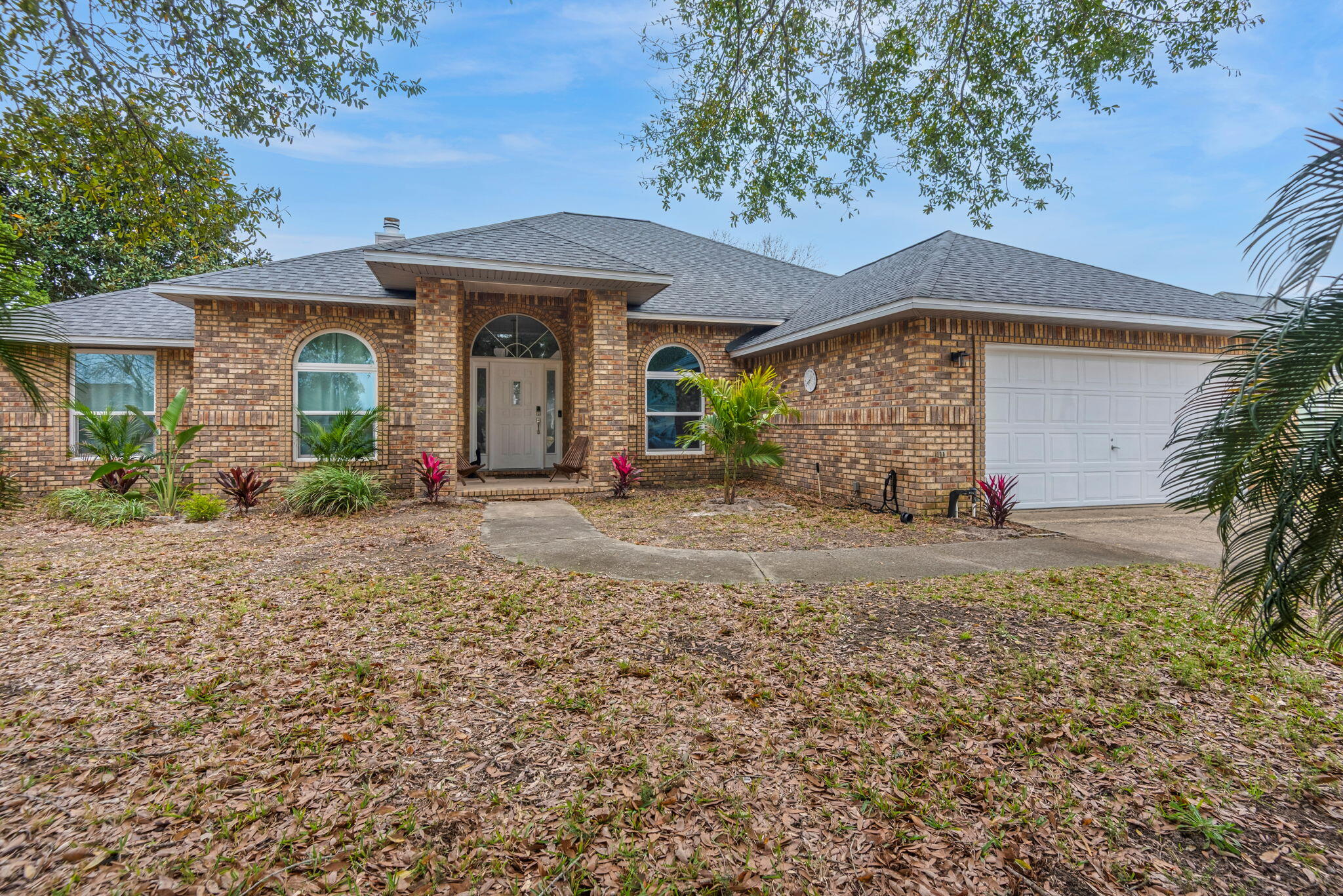 Experience Florida living at its finest in this impeccably renovated all-brick pool residence, gracefully situated within the prestigious Chevalier community. Fully functioning AirBnB with over $55,000 in profit in 2025! Thoughtfully redesigned with luxury flooring, designer lighting, stainless appliances, fresh interior finishes, and elegant linen drapery throughout, this home blends timeless style with modern comfort.

The open, light-filled floor plan showcases soaring ceilings, multiple skylights, and a striking fireplace that anchors the main living space. The beautifully renovated kitchen offers abundant cabinetry and expansive counter space, ideal for both everyday living and entertaining. The spacious primary suite accommodates oversized furnishings and features a spa-inspired bath complete with an oversized tiled shower and jetted tub. A split-bedroom layout ensures privacy, with generously sized secondary bedrooms and a well-appointed Jack and Jill bath.

A climate-controlled sunroom adding substantial additional usable space provides endless versatility for a second living area, executive office, or recreation room. Outdoors, enjoy a sparkling inground pool, resurfaced deck, and a fully fenced private yard with irrigation system and storage shed. Recent upgrades include a 2020 roof, 2019 HVAC, hurricane-resistant windows, and updated electrical. Ideally located just minutes from Pensacola's renowned white-sand beaches and exceptional dining.