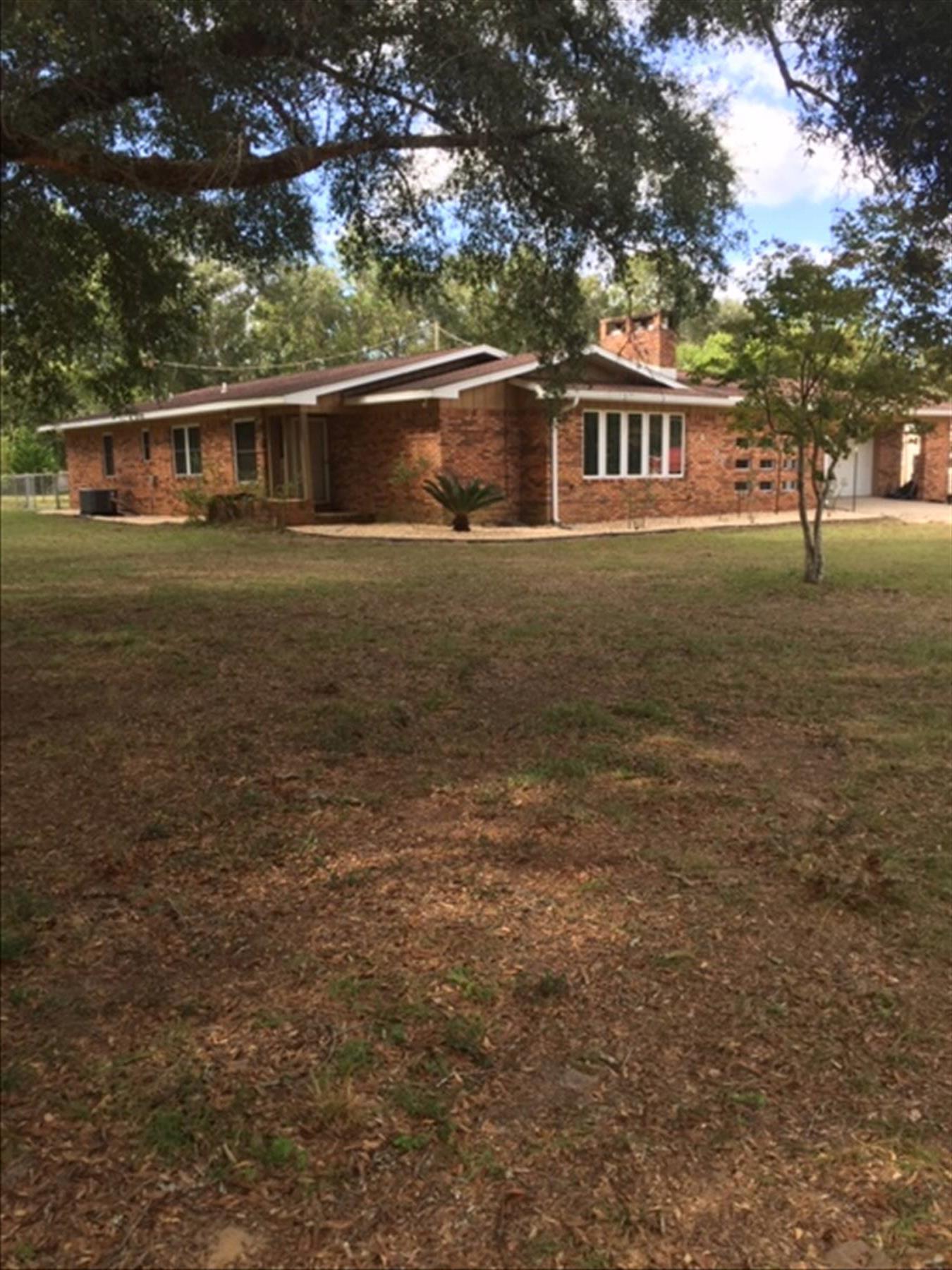 Unicorn, rare find, hurry!! 4+ ACRES South of I-10!!!  5 Bed/3 Bath Total- 3/2 brick main home with incredible kitchen, 2 Bed /1 Bath Guest House. Kitchen completely upgraded; 'Venation Gold' Granite counter tops, Whirlpool Gold 6 burner radiant cook top, Whirlpool Gold dishwasher, built in double oven with standard and convection features, microwave, no expense spared. Pella windows and sliding doors, 20 year transferable roof warranty, furnace and A/C upgraded (10 year warranty). Zoned Ag; Horses/chickens/animals welcome with water well, no restrictions! In ground swimming pool with brand new 3k saltwater system (upgraded 2020), magnet motor (upgraded 2020), new pool liner (2019), zero hassle to maintain.  Never starve as the property has apple, pear, citrus, tangelo, lemon, pomegranate, blueberry, blackberry, and 4 types of grapes.  <10 minutes to Duke, 7th Group, Walmart. $10k Solar inverter upgraded 10/2020 to 8000-Watt Sol-Ark EMP hardened.  Never lose power. This property has it all and will not last long.