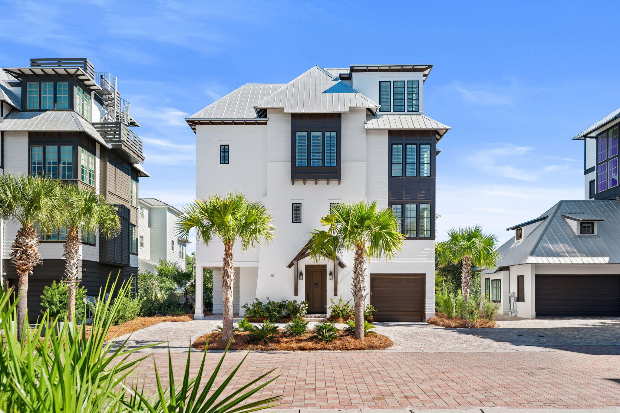 Modern coastal charm is delivered by esteemed local builder Cole Construction. This luxurious home is tucked away in the beautiful community of Tresca Place. Enjoy Gulf and lake views. Bike, walk or take a golf cart to the beach, restaurants and shops close by. The location allows you to be close enough to all of the fun while enjoying the serenity of this small community. Coastal elegance is displayed throughout the entire home's interior finishes. White oak flooring, Carrera marble and nickel gap walls are just a few of the fine touches. The kitchen features GE Monogram professional appliances, marble countertops including a waterfall island perfect for the chef who loves to entertain.This expansive 4 floor retreat is complete with an elevator. Primary or vacation, make it yours!