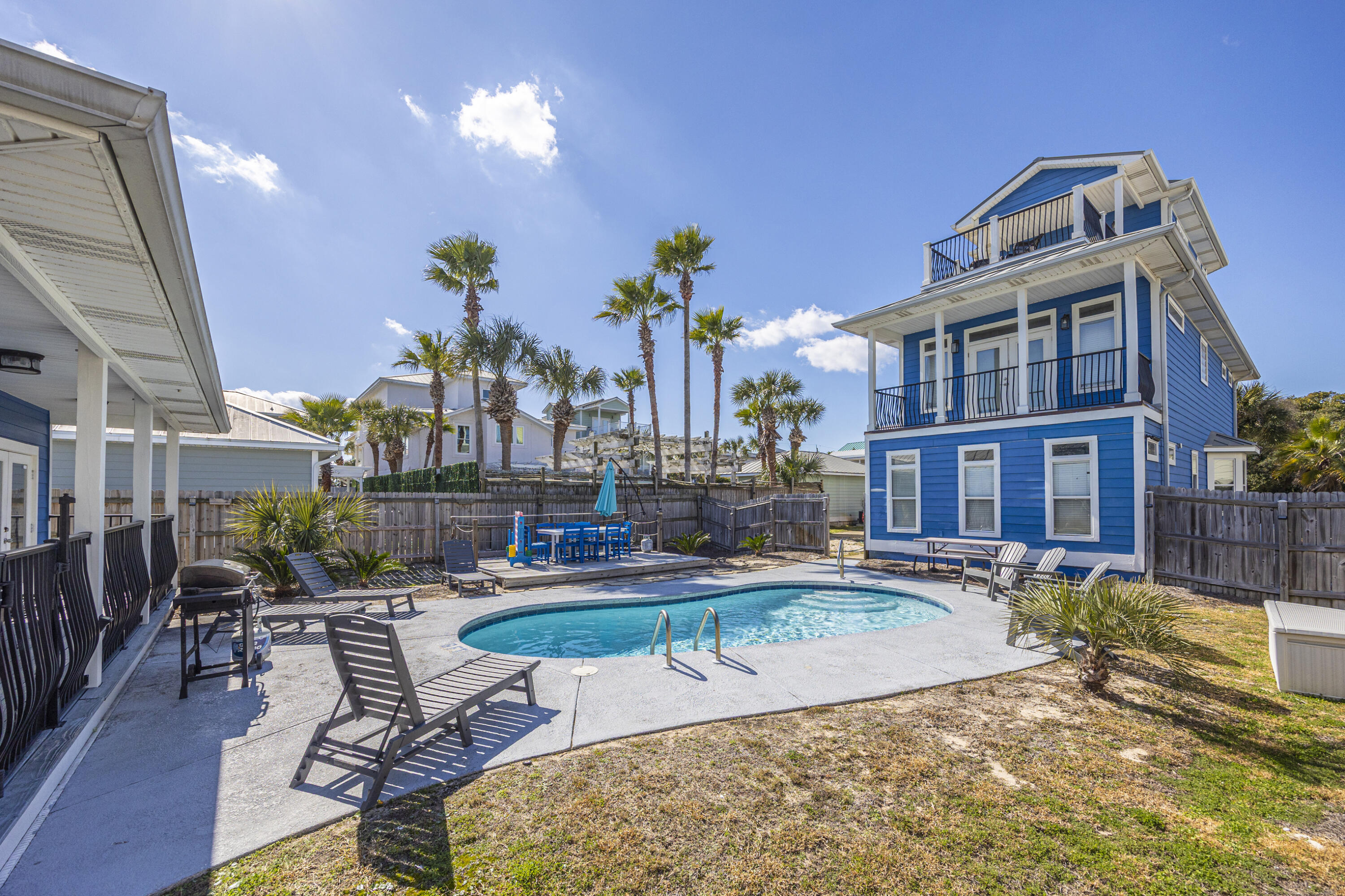 Located in the highly desirable Crystal Beach community, this exceptional three-story coastal retreat offers a rare ''two homes in one'' configuration just under one block from Destin's renowned white-sand beaches. The property includes a golf cart, making beach access and cruising the neighborhood effortless and convenient. 
The main residence features 4 bedrooms, while a separate 2-bedroom carriage house provides additional privacy and  flexibility, perfect for multi generation living, hosting guests, or maximizing rental income. Together the property comfortably accommodates up to 18 guests,  making it perfectly suited for both personal enjoyment and strong short-term rental performance. Designed for coastal living & entertaining, the home offers multiple outdoor spaces including four private balconies, peek-a-boo Gulf views from the third level, and a fully fenced backyard with a heated pool & expansive deck. The thoughtfully designed interior spans three levels and features multiple en-suite bedrooms, a third-floor loft with kitchenette, and open-concept living, dining, and kitchen areas ideal for gathering.

The carriage house includes two bedrooms, a full bathroom, walk-in closet, and kitchenette ,providing a private retreat for extended stays or guest accommodations. Additional highlights include ample parking and generous storage throughout. 

From an investment standpoint, the property has demonstrated strong rental performance, generating $163K in rental income in 2025, with $109K already booked for 2026 to date. Centrally located near Destin's premier dining, shopping, and entertainment, this home delivers an exceptional blend of coastal lifestyle, prime location and proven income potential in one of the area's most sought-after beach neighborhoods.