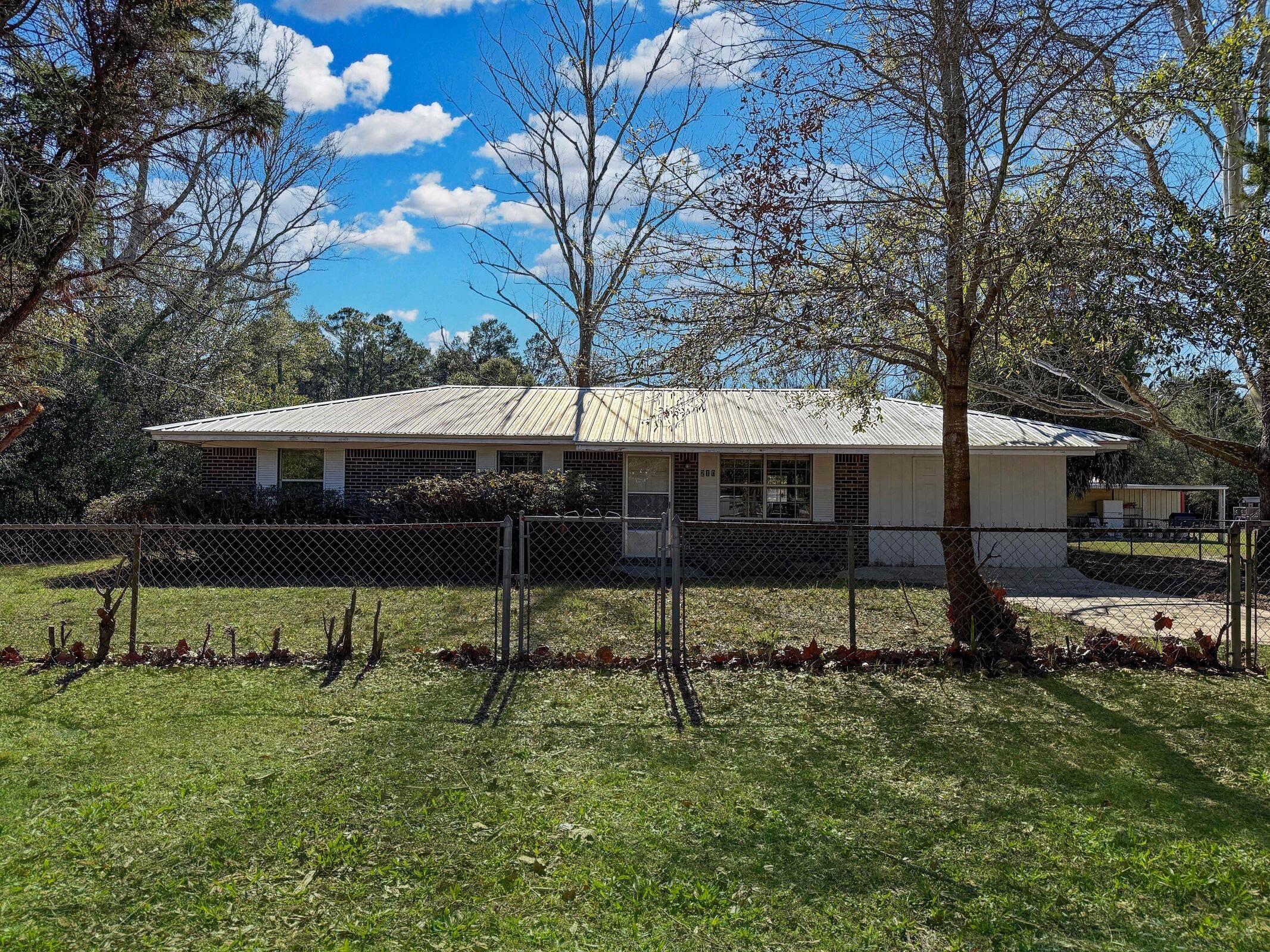 Located on a pleasant residential street, this 3-bedroom, 1-bathroom single-family REO home offers 1,008 square feet of functional living space and sits on a large 0.79 acre lot. NO HOA. The fully fenced yard includes an outdoor shed/barn, providing additional storage for vehicles, boats, tools and more. The interior features a sliding glass door leading to back patio and backyard. Located in the heart of Defuniak Springs, local amenities such as shopping, schools, recreation, dining and major highways have never been more accessible. This property presents a great opportunity for those looking to personalize a home or seek an investment opportunity. Don't miss the potential this home has to offer. Call and schedule your showing today.