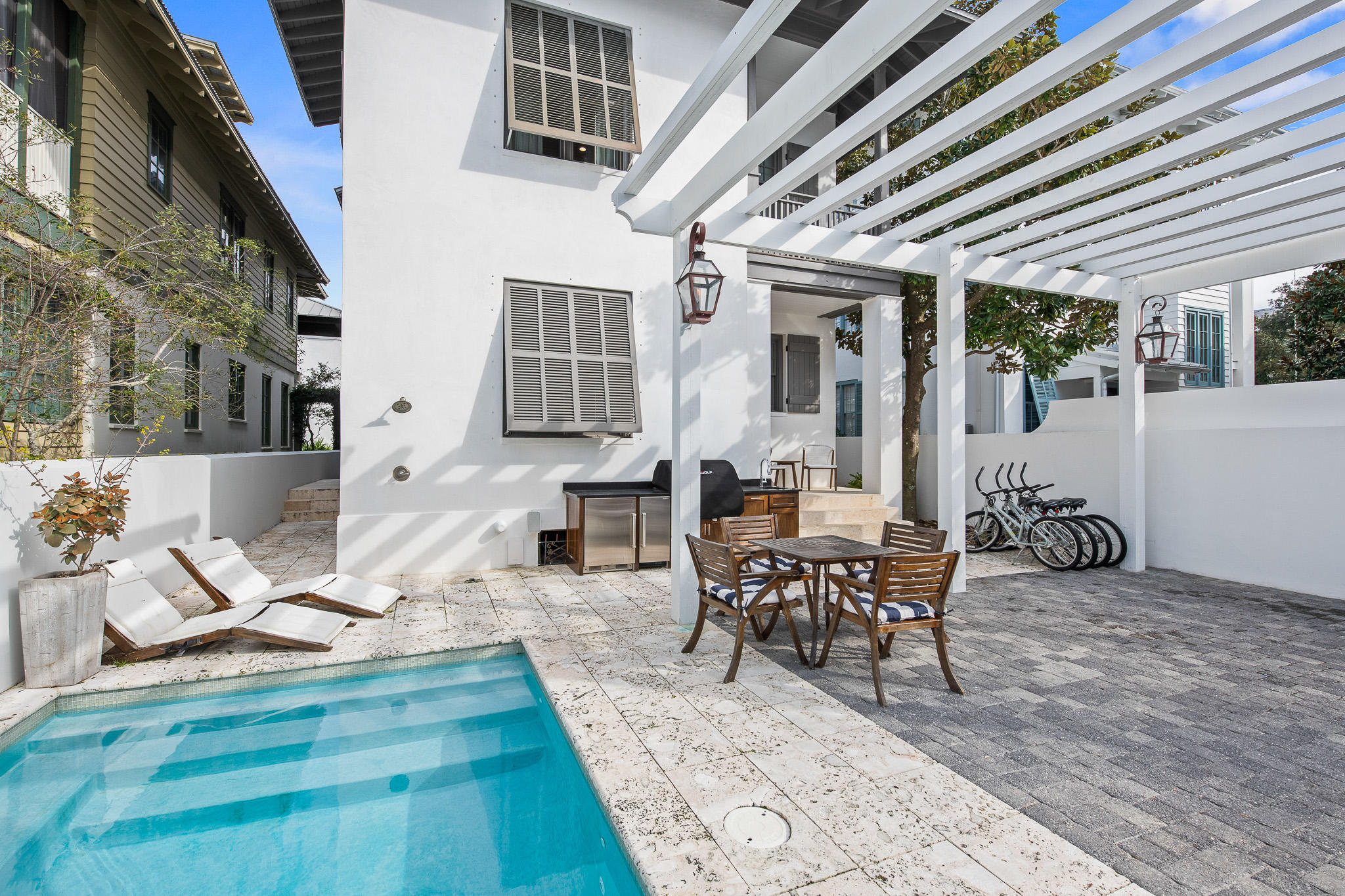 Poised just four tiers from the beach on Rosemary's Gulf side, this exquisite custom home with private pool boasts a highly coveted location just 100 steps to both the beach and Rosemary's lively Town Center with all of its amenities, restaurants, and shopping.  ''Rosemary Bluegrass'' was renovated from the ground up in 2017 by renowned custom home builder Matt Fuller and interior design firm Kay Fuller and Sons, using impeccable finishes that exude a high-design beach house with crisp coastal elements. Elegantly constructed with attention to every detail, the home has jaw-dropping finishes utilizing reclaimed barn-wood from the Bluegrass Country of Kentucky... Hand-hewn beams adorn the vaulted ceiling in the living area and master bedroom. Other accents include vintage oak flooring & doors, antique Italian tile, Venetian plaster walls, and Calcutta Gold marble countertops.  The indoor and outdoor kitchens are equipped with new Sub-zero and Wolf appliances and top-of-the-line countertop appliances fit to inspire any chef. The new living room is tastefully decorated around a charming gas fireplace.  The house has four bedrooms, four and one-half baths, and accommodates up to ten guests. A bunk room on the third floor is a perfect hangout for the kids.  Laundry rooms on both the first and third floors provide total convenience.
The front porch is nestled against one of Rosemary's main boardwalks leading to the beach.  This inviting sitting area opens from the master bedroom and is shaded by Rosemary's natural overhanging foliage.  It's a great spot to enjoy a morning cup of coffee made in your personal coffee nook encompassed within the master bedroom suite.  If you need a little more refreshment, both suites on the lower floor have access to a convenient wet bar located in the foyer complete with built-in Sub-zero ice maker/refrigerator, wine refrigerator, and sink. Parking for two cars is available under a pergola in the gated courtyard, and an additional spot is available on Hope Town Lane.  The courtyard also accommodates a heated swimming pool and outdoor kitchen complete with premium grill, refrigerator, and ice maker.
For those into high-tech entertainment, there is a custom surround sound system with Sonos sound bars installed in both the living room and master suite complete with speakers throughout the house, on the porch, and by the outside pool.
Attractive as either a secondary home or an investment property, the home is projected to generate over $290,000 in gross revenue. You and your family are certain to enjoy the Southern charm & hospitality inspired by the rolling hills of old Kentucky rooted in the heart of Rosemary Beach.