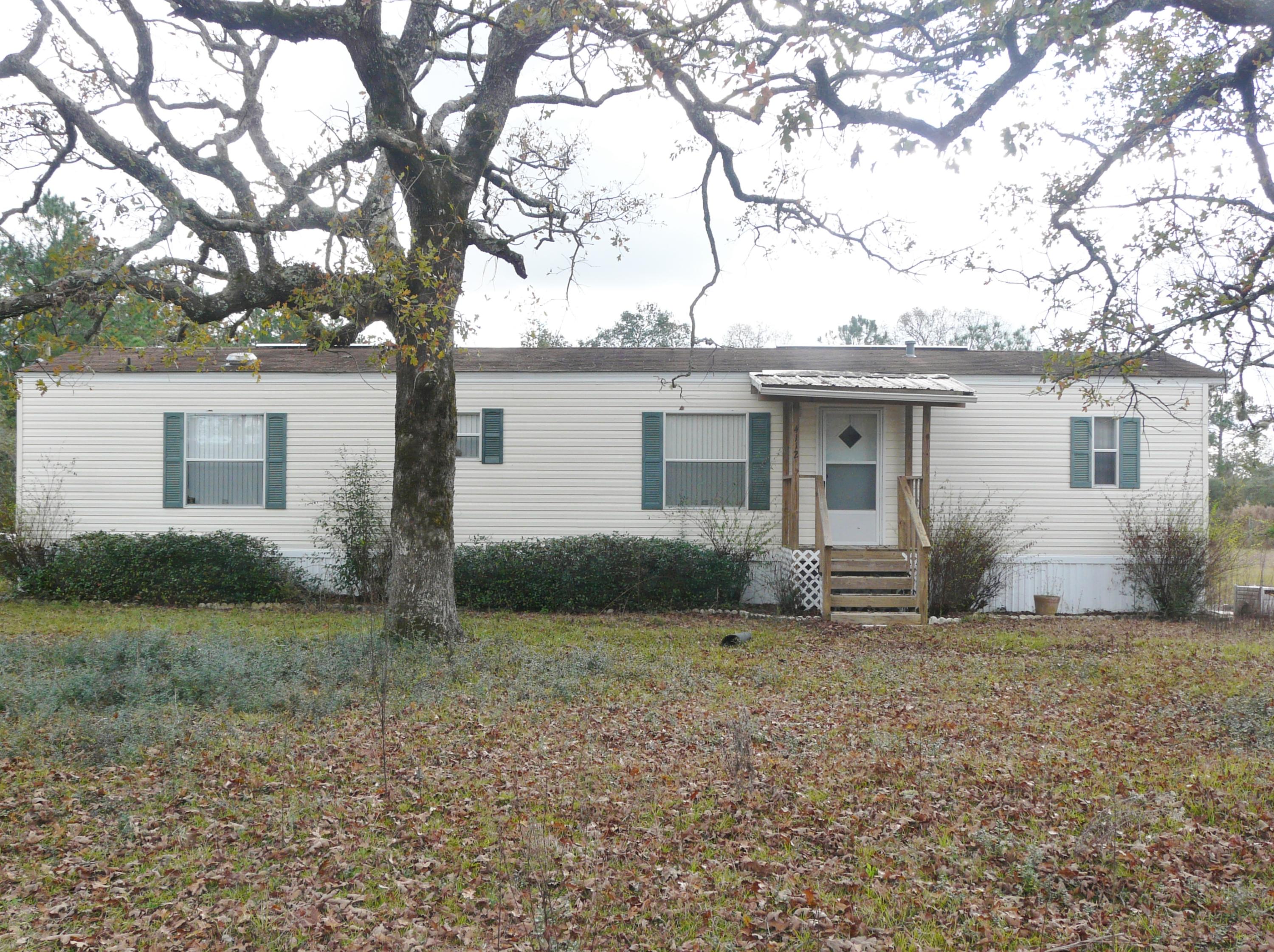 One acre in the country just outside town with nice new porches to sit and relax. No city taxes. Built in 2002, and plenty of room to entertain in large living room and kitchen. Two bedroom, two bath home with a lot of parking area and room to play ball with the kids or friends. Wonderful old trees and plenty of room for garden. Yard fenced on three sides. Come see this home at fantastic price. Outside shed does not stay.
