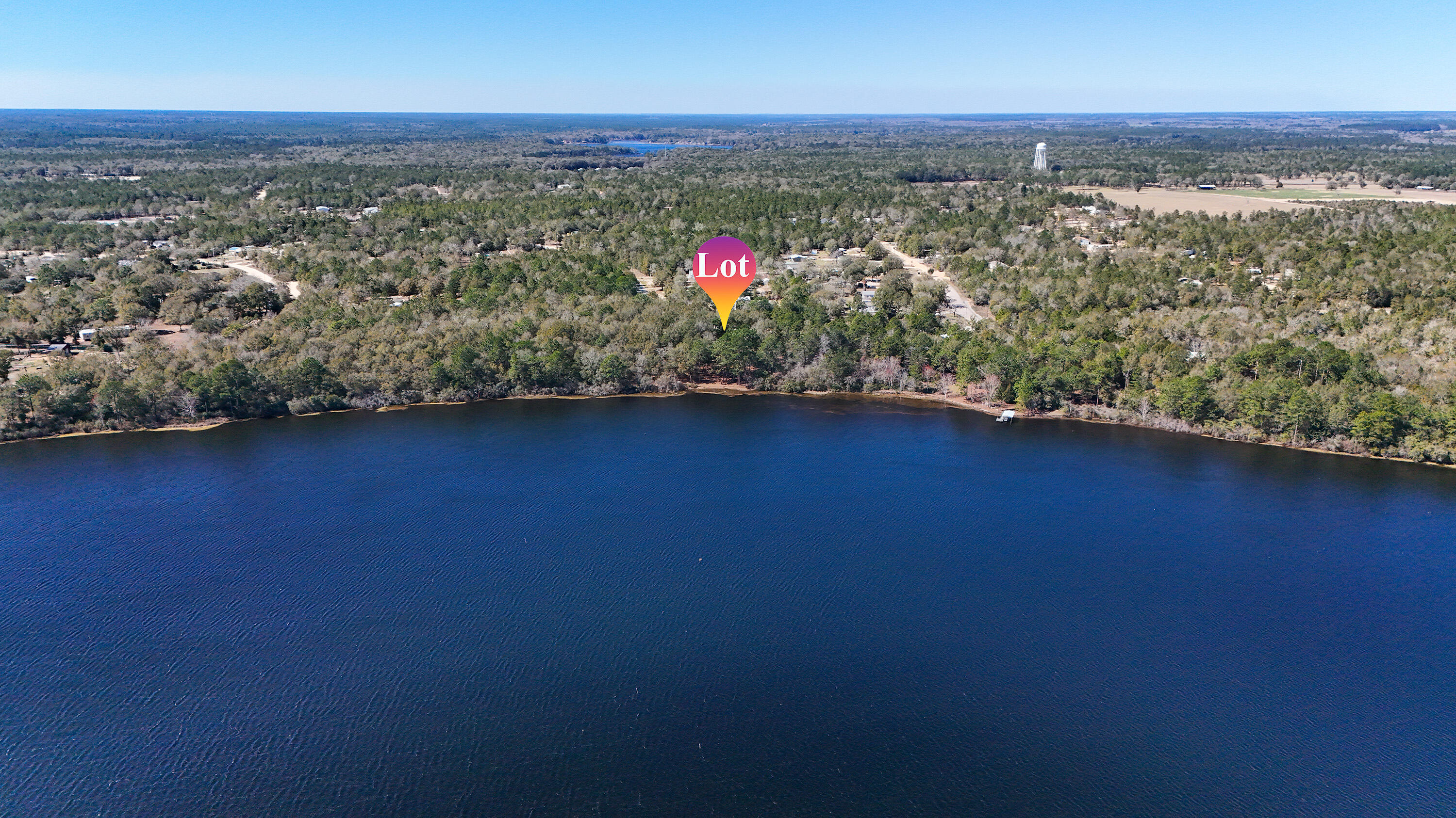 Beautiful Juniper Lake waterfront lot ready for your dream home! This 500+ acre lake is perfect for canoeing, kayaking, swimming, and is well known for excellent bass and bream fishing. Enjoy peaceful lake views from the 20' x 12' deck, ideal for morning coffee or evening relaxation. The land has been thoughtfully cleared with space for an RV while you build. Mature trees line both sides for added privacy. Features include a 12' x 12' wired metal building for storage or hobbies and a 90-foot retaining wall that enhances both function and appeal. Schedule your showing today!