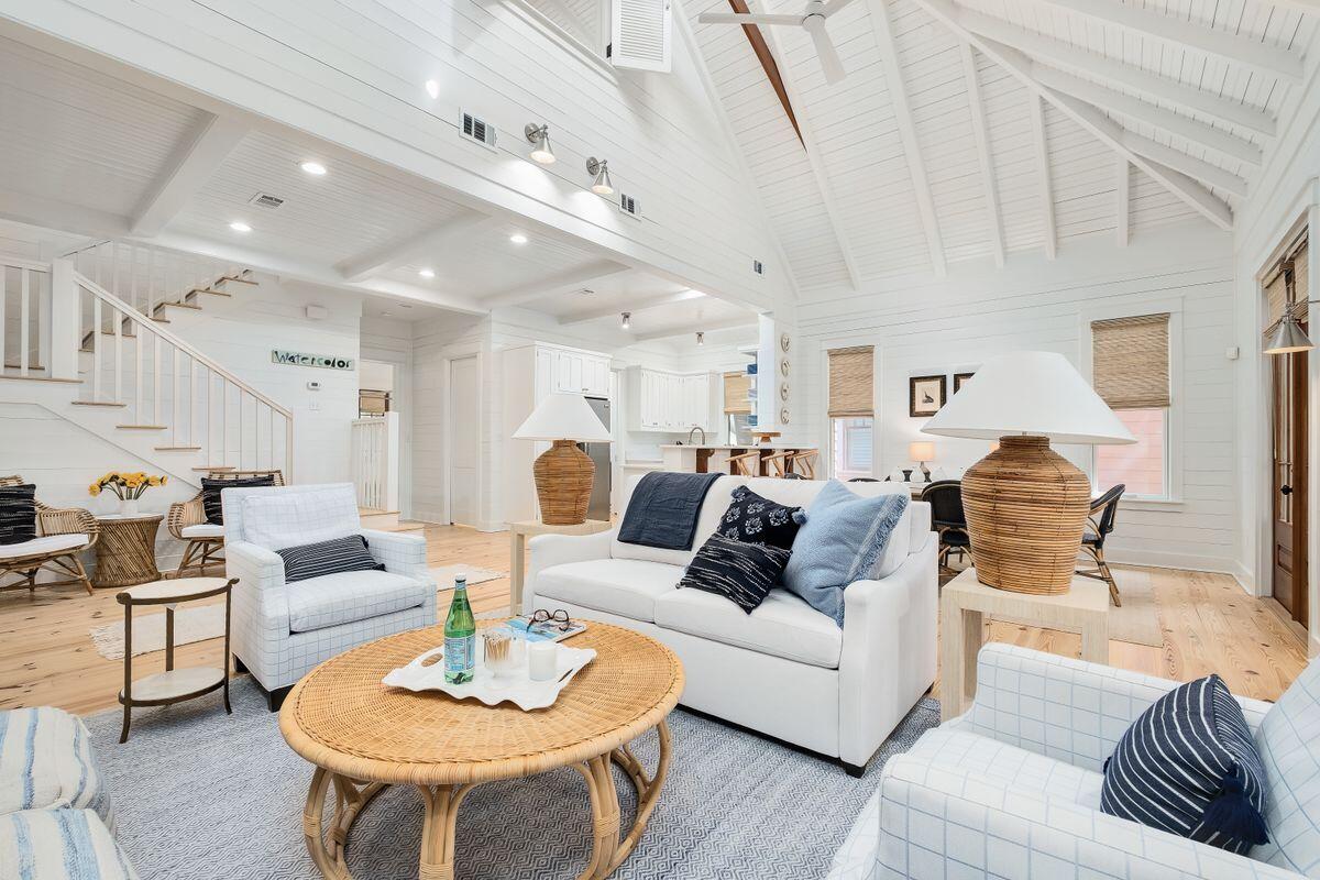Imagine stepping into a Serena & Lily showroom — this upscale beach cottage is casual and coastal, relaxed, yet refined. This picture-perfect cottage is ideally located in phase 1 of WaterColor, a short stroll to the LakeHouse pool, WaterColor Beach Club and the Gulf of Mexico. This two-bed, two-and-one-half bath home is the perfect marriage of openness and coziness. Spread over more than 1,700 square feet, this Rose Garden Mews home enjoys views of Crimson Park from the kitchen, living and dining rooms. Cathedral and beamed ceilings complement three sets of French doors and large windows to create an airy and spacious feel. A first-floor owner's suite features an ensuite bath with dual vanities and both a shower, soaking tub and access to a screened rear porch. Top-of-the-line furnishings, mostly from Serena & Lily, outdoor furniture from Pottery Barn and refined hardwood floors, as well as built-in bookcases with fireplace and exquisite porches add to the home's charm and ambiance. The second floor features an oversized guest room large enough for two queen-sized beds. Notable updates to the home include new HVAC; mold remediation; refinished floors; quartz countertops; hardware in baths; kitchens and living room cabinets; cleaned and re-grouted tile; interior and exterior paint; exterior pressure washing; trimmed trees; repaired fireplace and BBQ grill; new lighting and ceiling fans; new Hunter Douglas wood blinds; Kathy Kuo barstools; Chairish vintage coastal decor; and, Modus Photography and Mary Hong artwork. The WaterColor Beach Club has been newly expanded and includes three pools (one gulf-front). This home offers deeded beach access as well as amenities ranging from watersports on Western Lake to tennis courts to walking and bike paths. Enjoy easy access to the shops and restaurants in WaterColor's Town Center and 30A's iconic seaside communities beyond.