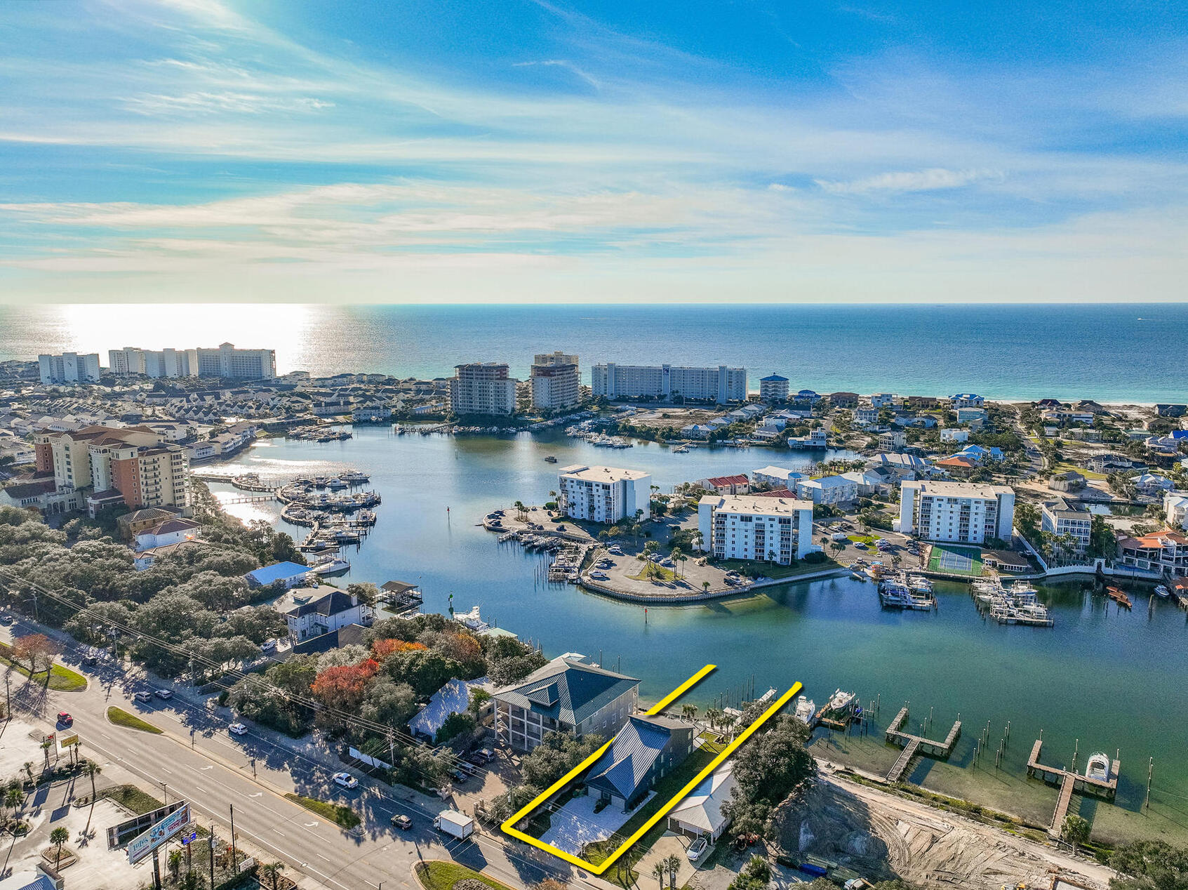 DUPLEX on the SCENIC HARBOR in Destin, Florida! NO HOA! ENTIRELY GUT-RENOVATED duplex featuring two enormous, DEEP-WATER BOAT SLIPS and a 100% new dock, deck, pier, and pilings. The entire duplex (first and second floor units) and its two homes incorporate the latest features, finishes, and building technologies pursuant to the current building codes. The new cutting-edge ES windows and doors contain impact-resistant glass throughout. Both homes contain new 'whole house' generators. The second floor features a vaulted ceiling, loft with bunks, two large bedrooms and two bathrooms, and an abundance of closet space. The second-floor deck is custom-milled from Ipe and is beautifully installed through its concealed fastening system. The custom tempered glass balustrade that.. surrounds the expansive deck allows for unobstructed fabulous view corridors of the scenic harbor and Gulf of Mexico. A custom-fabricated aluminum spiral staircase allows for access from the upper deck to the first-floor concrete patio. The first-floor features two large bedrooms and two bathrooms, also an abundance of closet space. The concrete floors on the rear patio and garage have been finished with a superior epoxy coating applied by Ninja Coatings. Both units feature all new spray foam insulation on all exterior walls and under the decking of the new standing seam metal roof, resulting in significant utility cost savings. Both units contain all new drywall, flooring, bathrooms, kitchens, appliances, fixturing, wiring, cabling, plumbing, etc...Fiber optics is wired throughout, and high-tech security cameras surround the entire exterior structure, recording all activity in 4K high resolution. Low voltage wiring was also installed for custom window treatments resulting in the utmost privacy when desired. The new gutters are custom fabricated by a German-manufacturer. Culligan has installed a water filtration system, which services both homes. A new well and pump has been installed to irrigate the landscape. The new Carrier HVAC systems are also accompanied by all new ductwork throughout. Two exterior mounted, new gas tankless hot water systems replaced the outdated interior hot water tanks. There are (16) gas lanterns surrounding the exterior that display fabulous ambiance. The enormous garage is climate controlled but is not calculated in the approximate 3,500 square foot of conditioned interior living square footage that is identified in this listing. The new custom garage doors are insulated with new side-mounted openers. The garage door tracks have been powder coated white. Both sides of the garage have been pre-wired for electric car charging. The deepwater boat slips measure approximately 18.5' x over 50' and 14.5' x over 50'. All improvements involved permitting and approvals through the City of Destin, with the design and reconstruction by a Licensed Architect, Engineer, and General Contractor. Please inquire for further details and to schedule a private showing. All showings require a minimum of (24)-hours of advanced notice and the listing broker must accompany all showings.  No trespassing shall be permitted.  MatterPort [approximate] floor plan(s) are uploaded to this list under the 'Documents' tab.