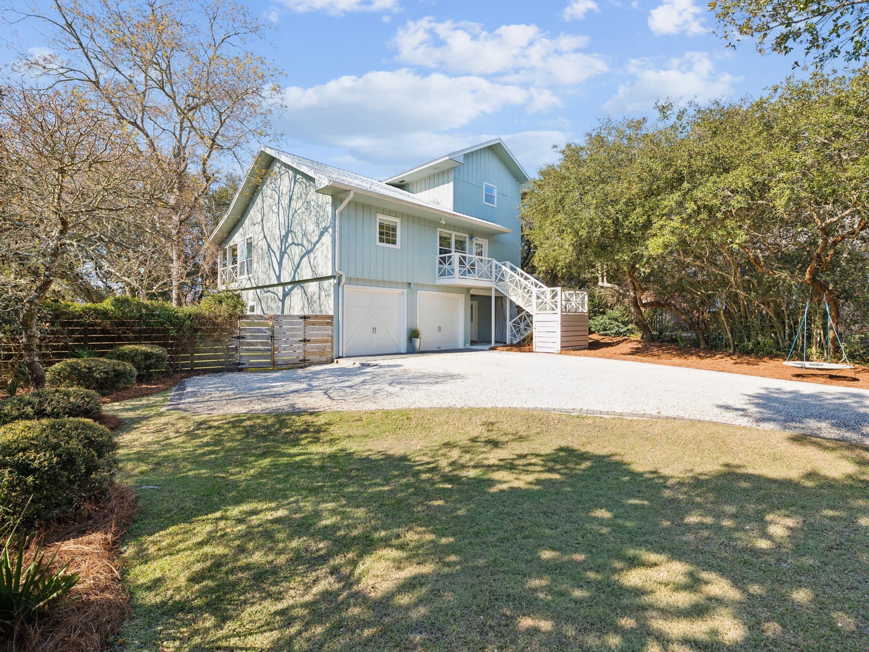 Located on a spacious quarter-acre lot in the Beach Highland community of Dune Allen, this 3 bedroom, 3 bath home offers an excellent opportunity for a primary, second home, or vacation rental with just a short stroll to the public beach access across from Stinky's restaurant. The main living areas occupy the second and third levels, featuring an open-concept kitchen and living room with vaulted ceilings and access to a spacious porch overlooking the backyard. The kitchen includes a large island, farmhouse sink, and beadboard cabinetry for a classic coastal feel. The tree-lined backyard provides ample room for a swimming pool to be added. The second level includes a guest bedroom, full bath, and laundry, while the third floor primary suite offers a walk-in closet, en-suite bath, and bonus flex space. The ground level features a separate lock-out apartment which includes a kitchenette, living area, bedroom, bath, and laundry. A perfect, private first floor guest suite. Come enjoy all that Beach Highland has to offer.