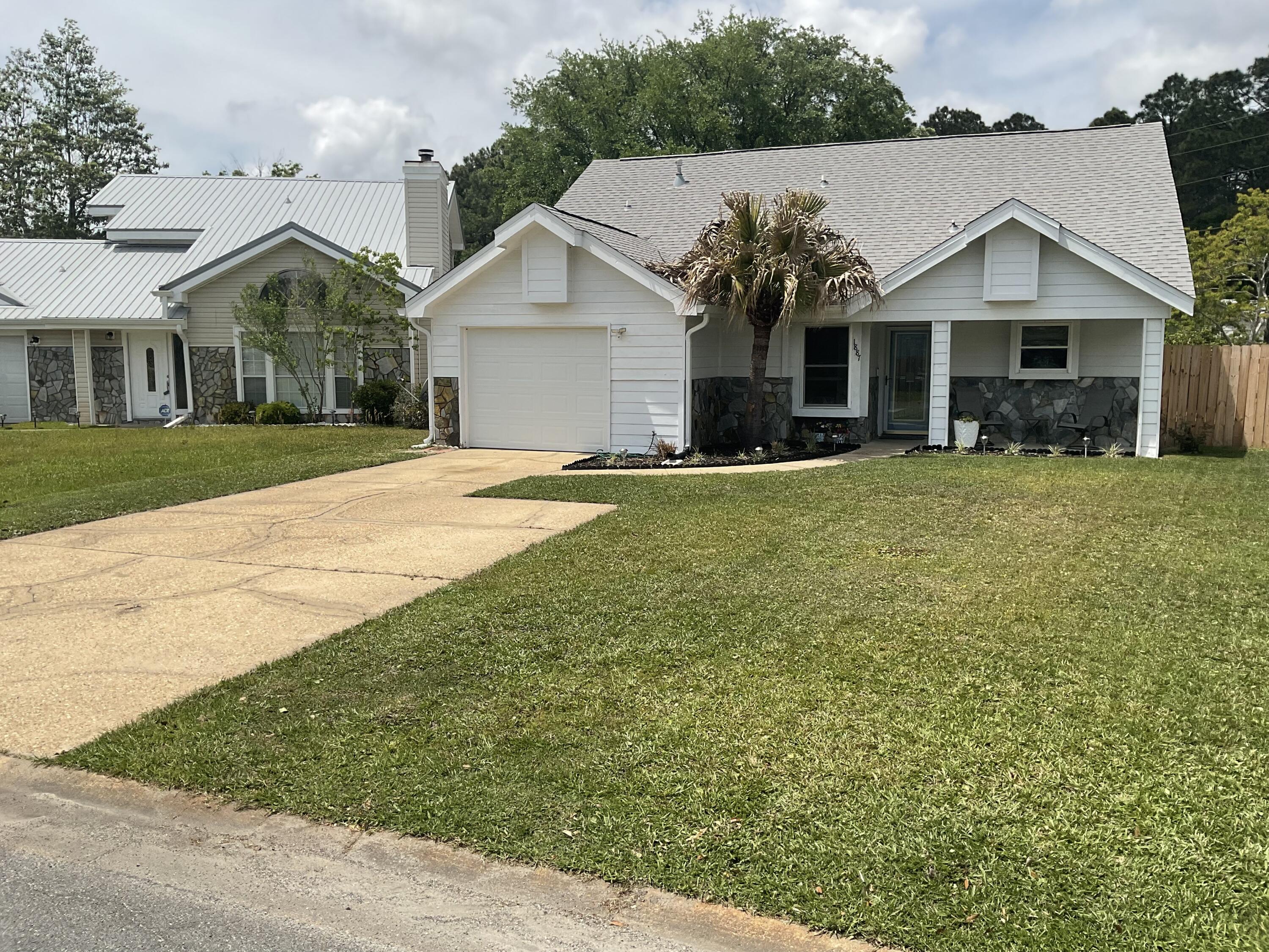 Welcome home to the cutest cottage in Fort Walton under $2k/mo. Ideally located near military bases, schools, and shopping...this property has it all!! Fantastic curb appeal & lots of natural light makes this desirable home even more charming! Step inside to a main living area with tall ceilings and a cozy fireplace. Well maintained flooring with low maintenance tile & LVP throughout the house. The open concept kitchen features stainless steel appliances (all warranted) and granite countertops. The spacious master bedroom includes vaulted ceilings and a sliding glass door, while the attached master bathroom features an updated double vanity sink and large tub. Washer, dryer and garage fridge included (all non-warranted). Last, but not least...the private backyard oasis is perfect for enjoying the Florida sunshine! Pets Considered. Don't miss out on the opportunity to make this house your home. Contact us today to schedule a tour!