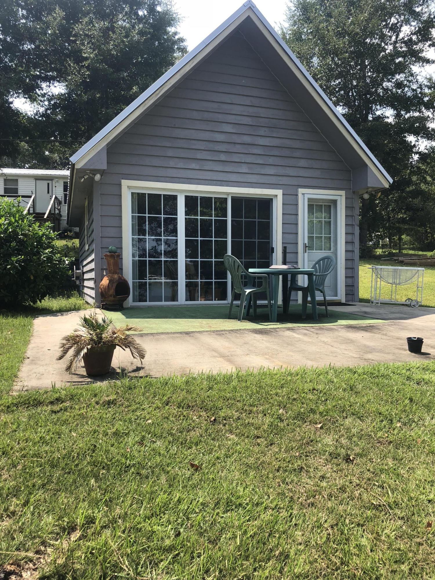 Perfect location for a waterfront weekend getaway, convenient to the Emerald Coast. The 3 bedrooms include a cabin (16' x 24') & a manufactured home (16' x 66'). The dock has been upgraded with stainless steel screws & painted with restore paint. There are 2 septic tanks & 2 electrical boxes, one for each building. Manufactured home is surprisingly spacious with plenty of storage options. Home includes all current furnishings. The cozy cabin has a great view overlooking the property & the lake. It includes a kitchenette & bathroom. Also included is a 2002 32' Landau Motorhome with 20,000 miles. The property is landscaped with fruit trees, blueberry bushes & a lot of greenery. Don't miss out on this opportunity to own a unique property! Make your appointment today to view this oasis!