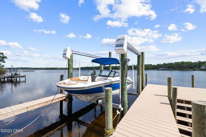 Best lot for sale on Lake Powell! Priced well under sales comps, this lot features high elevation & soaring views across 103 feet of LAKE FRONTAGE. Located directly on Florida's largest coastal dune lake, 22010 Lakeview Drive totals 0.74 acres & offers amazing proximity to 30A. The lot already has a boat lift & large dock which were added in 2022. The seller has spent considerable time & money on custom house plans for an amazing 2 story custom home with a private pool, carriage house, 3 car garage & around 4,000 SF! Lake Powell provides incredible boating, kayaking & fishing with the ability to also access the beach. One of the most unique features about Lake Powell is the ability to anchor your boat & go to the beach. Or simply kayak all the way in to the Gulf! This lot combines the best of beach and lake living located only 7 minutes from Rosemary Beach. Camp Hellen State Park has a newly-renovated dock with temporary parking & bathrooms. Come view this amazing lakefront lot today!