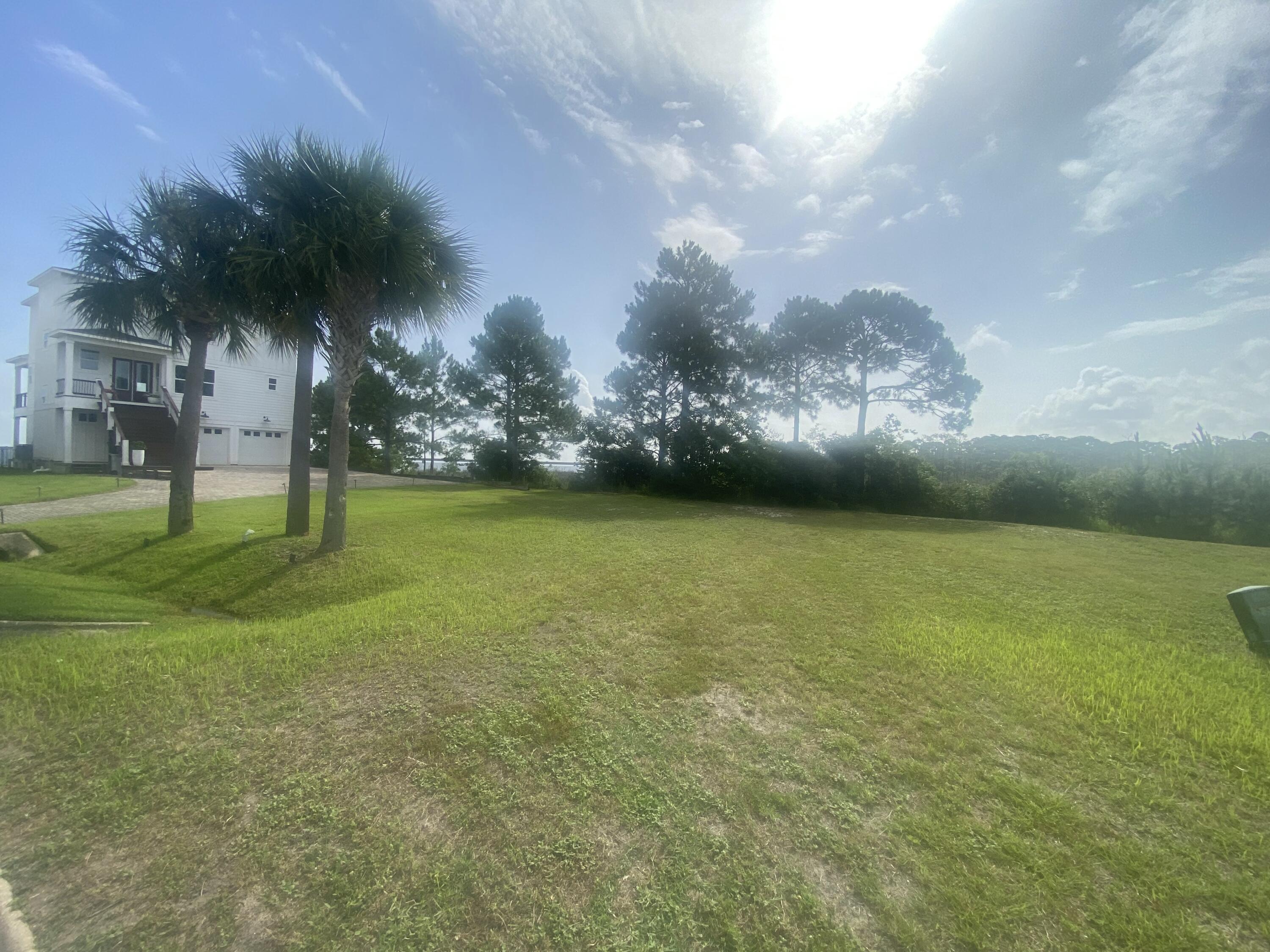 Nestled in the serene, gated community of Clipper Bay, this vacant lot offers a rare chance to craft your ideal home in a location that combines privacy, stunning views, and over 65' of waterfront on the bay, perfect for water enthusiasts who dream of kayaking, paddleboarding, or simply relaxing by the water.  This lot is ready to go with water connection, sewer tap & power. The lot boasts expansive views over picturesque marshland, creating a peaceful and natural backdrop for your future home.  Revel in panoramic vistas of two iconic landmarks—the Garcon Point Bridge and the Three Mile Bridge.  This lot offers flexibility in design while maintaining a generous space to incorporate outdoor living areas, gardens, or other personal touches.  Come see it today!