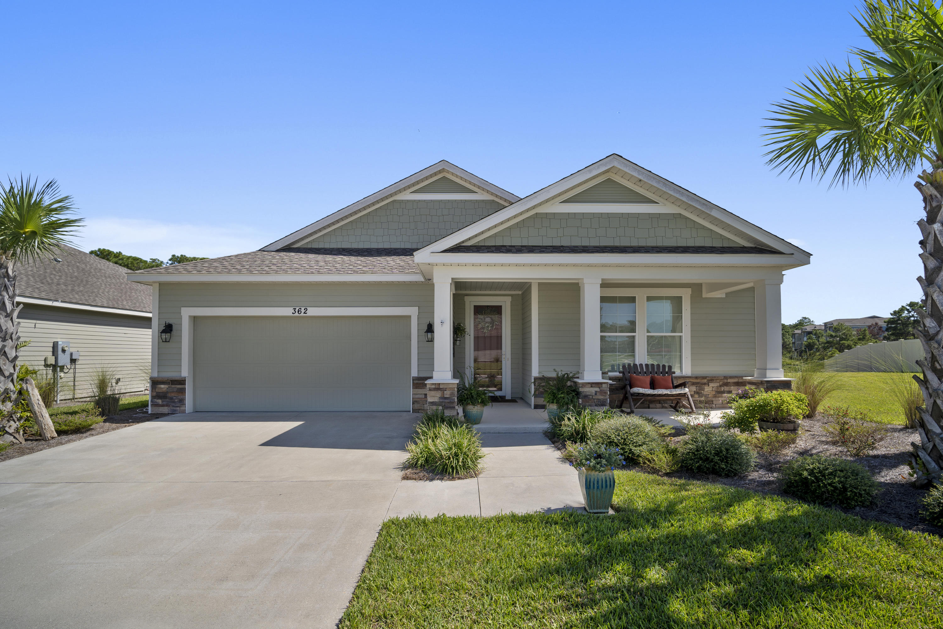 This beautiful Coastal Craftsman-style home located on the highly desirable West end of the beach will take your breath away! The 1800 SF interior exceeds expectations with its tasteful crown molding, modern luxury laminate flooring, and custom window treatments throughout. The open floor plan boasts a large kitchen with granite counters, SS appliances, plenty of cabinets with under counter lighting and upgraded back splash. The large master features a walk in closet, master bath with double vanities, a glass walk in super shower with pebble stone flooring. Beautiful french doors flow seamlessly from the elegant living area into the screened porch. Love to entertain? Invite guests out on the brick paver extended patio to grill, relax and to enjoy the pond view, star gazing or more This home offers plenty of privacy with a pond in the back and a lot to the side which is considered commons area and will not be built on. The exterior walls of the home are 2 x 6 with R19 insulation, R38 in the ceilings as well as R11 in the interior common walls to keep the sound down in the home. Large attic space over the 2 car garage offers extra storage. Whisper Dunes offers a community pool, dog parks, lighted sidewalks great for walking during the day and night. World's Most Beautiful beaches about 5 minutes away and close by is plenty of casual and fine dining, lots of shopping and entertainment and the airport is just 20 minutes away. All data and dimensions to be verified by BUYER.