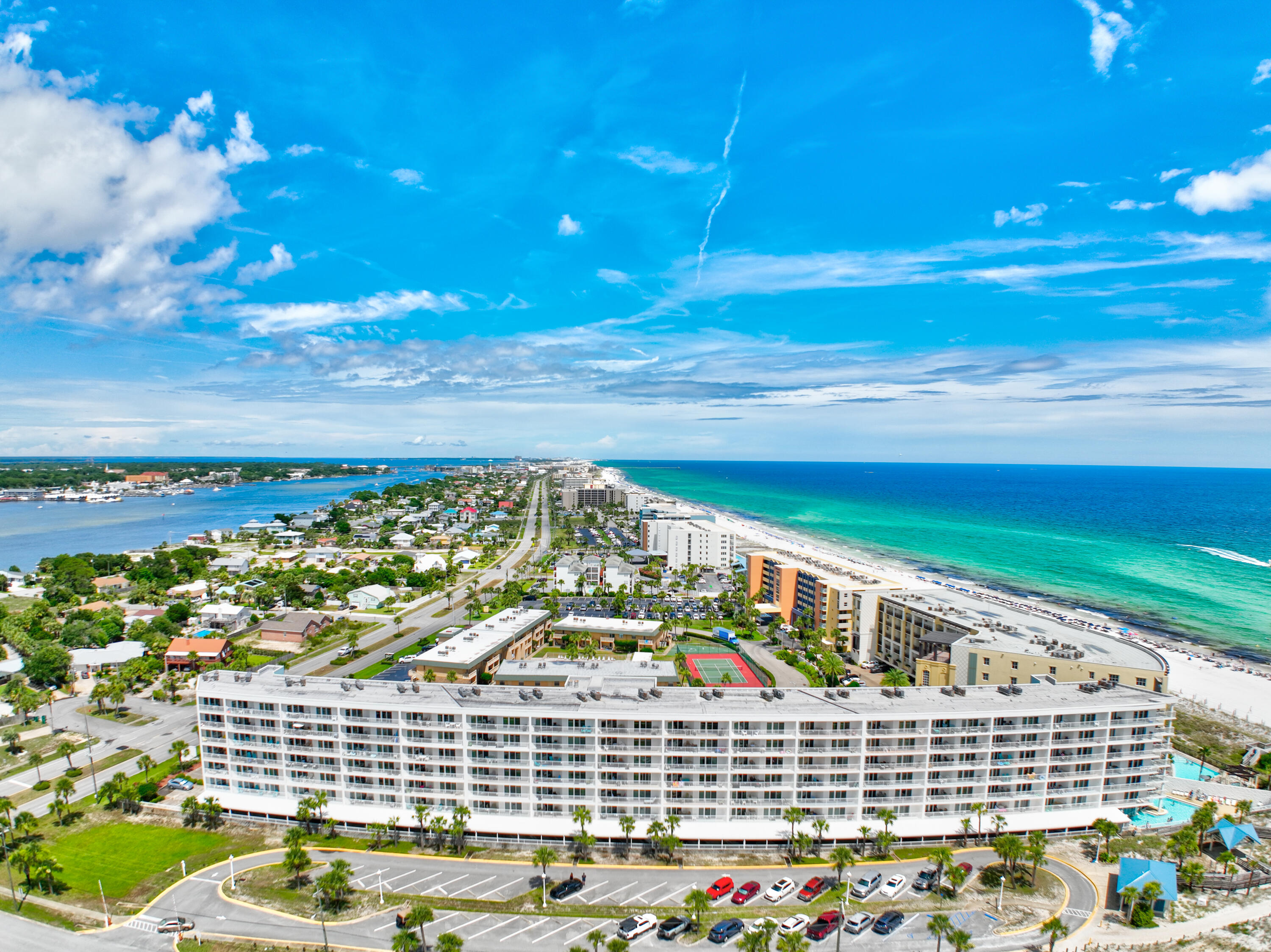 Seacrest Condominium built in 2000 on an angle to the Gulf of Mexico showcases fabulous views of the Emerald Green water and sugar white sand.  An Okaloosa Island public beach entrance directly accesisible from Seacrest offers a ramp with no steps to the beach.   No stairs to climb as there are elevators to all units making this condo and the beach handicap accessible. Park in covered garage in assigned space number 33.  LVP flooring throughout and Coastal Decor makes this unit light and bright.  Relax on the balcony and enjoy coffee and Gulf breezes.  Windows and sliding doors replaced in 2022. Swim in the heated indoor pool or outdoor pool, workout in the gym, and BBQ outdoors. New HVAC 2019, water heater 2018, fresh paint and stainless appliances add to the contemporary look!