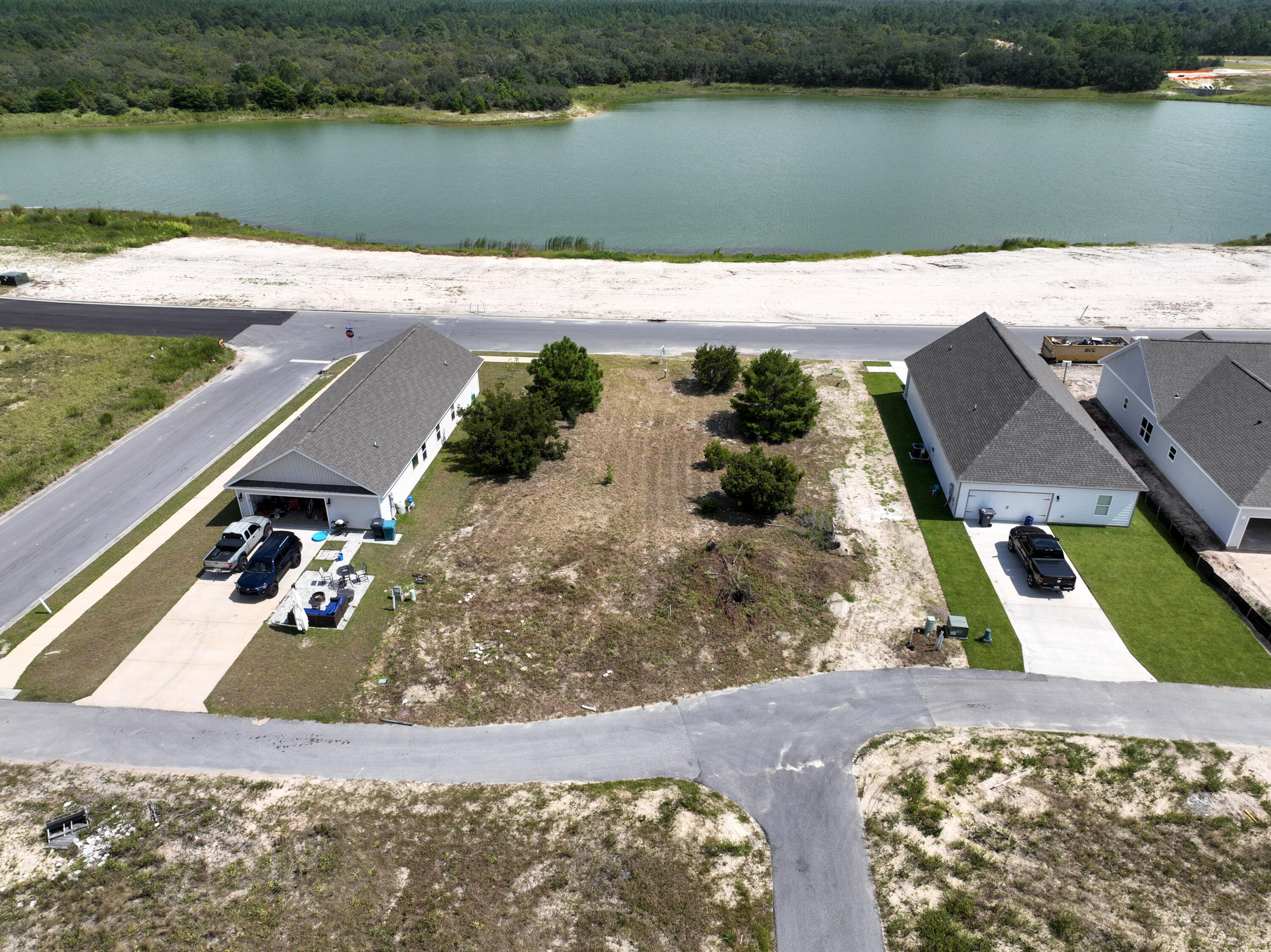 **BUILDER/MULTI-LOT DISCOUNT**Discover an extraordinary opportunity to acquire not one, but two valuable lots at a significantly reduced price. This unique offering includes the corner lot at Arrowwood and Huckleberry (MLS #977834) for a combined price of $139,000.  By purchasing these two lots together, you benefit from a consolidated transaction and a price that would not be available for individual sales. 

00 Bluebeech is a lake adjacent lot conveniently located off Hwy 331 with quick access to local schools, parks, shopping & restaurants. Only 16 miles from some of the most beautiful beaches in the World! Owl's Head Subdivision offers walking trails, a lake and large green space. Unobstructed lake views!  Don't miss out on this unique chance to secure a strategic investment or a dream location for your future home. This offer is available to anyone, so act quickly to take advantage of this special pricing.