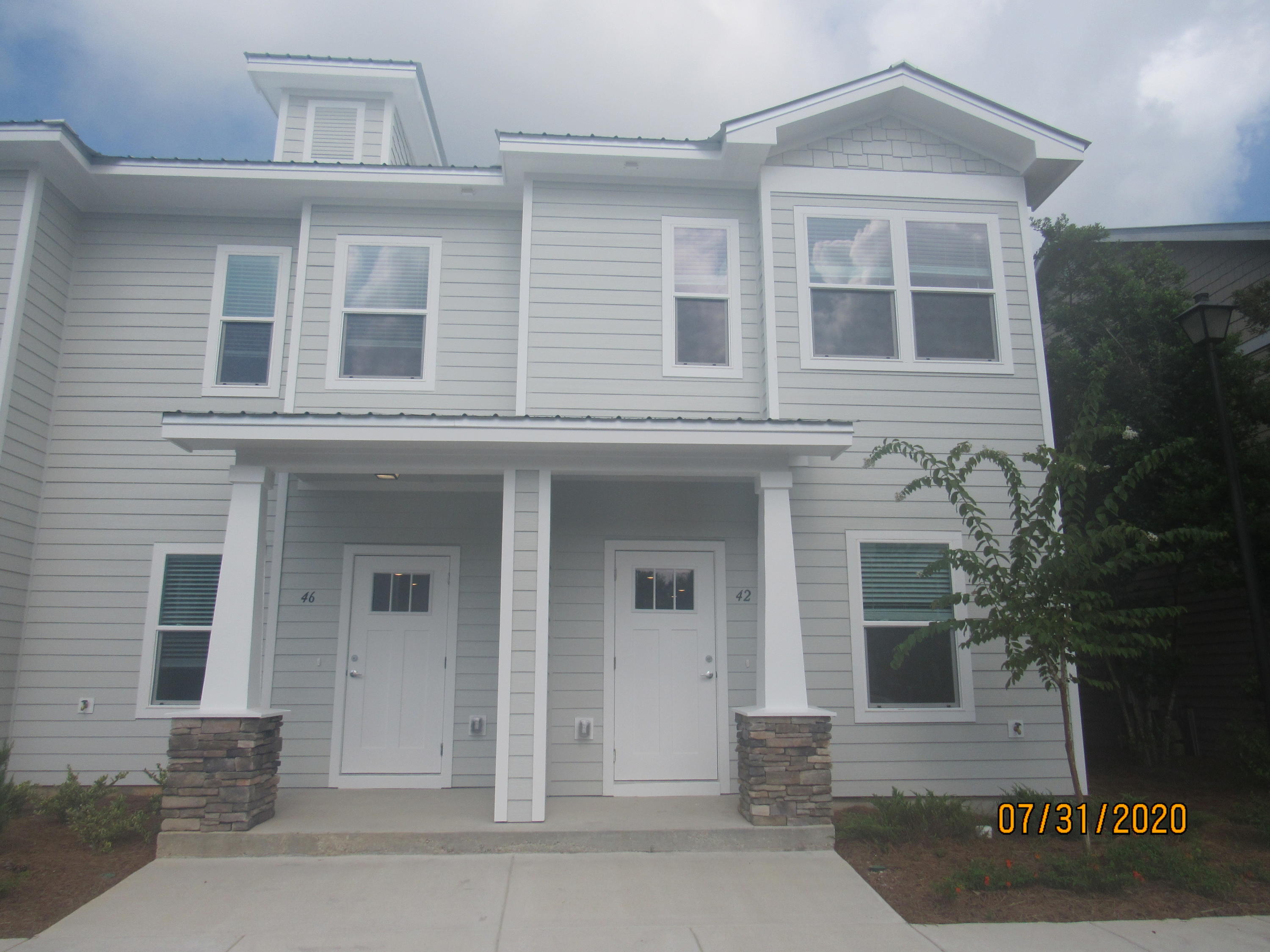 2020 Built, beautiful, 3 bedroom, 2.5 bath end unit town home with upgrades and a community pool! This lovely home is across the street from an elementary school, just down the road from a Publix shopping center, and a short, easy commute to the sugar sand beaches and emerald waters of 30a/SOWAL. It has fresh, neutral paint and no carpet throughout. The open floor plan on the first level includes a nice size living room with nook, eat-in kitchen with breakfast bar, gorgeous counter tops, plenty of counter/cabinet space, stainless appliances (including a flat cook top stove), and beautiful back splash, as well as a half guest bath with pedestal sink and a screened-in back porch. Upstairs, you will find the master bedroom, complete with an en suite, as well as two guest rooms sharing a full guest bath, and the laundry hookups (washer and dryer included in rental). There is plenty of storage. Pool care, lawn care, and garbage included in the rent. Pets may be considered on a case-by-case basis with prior owner approval and a non-refundable pet fee; no cats. NO SMOKING, including vapes.